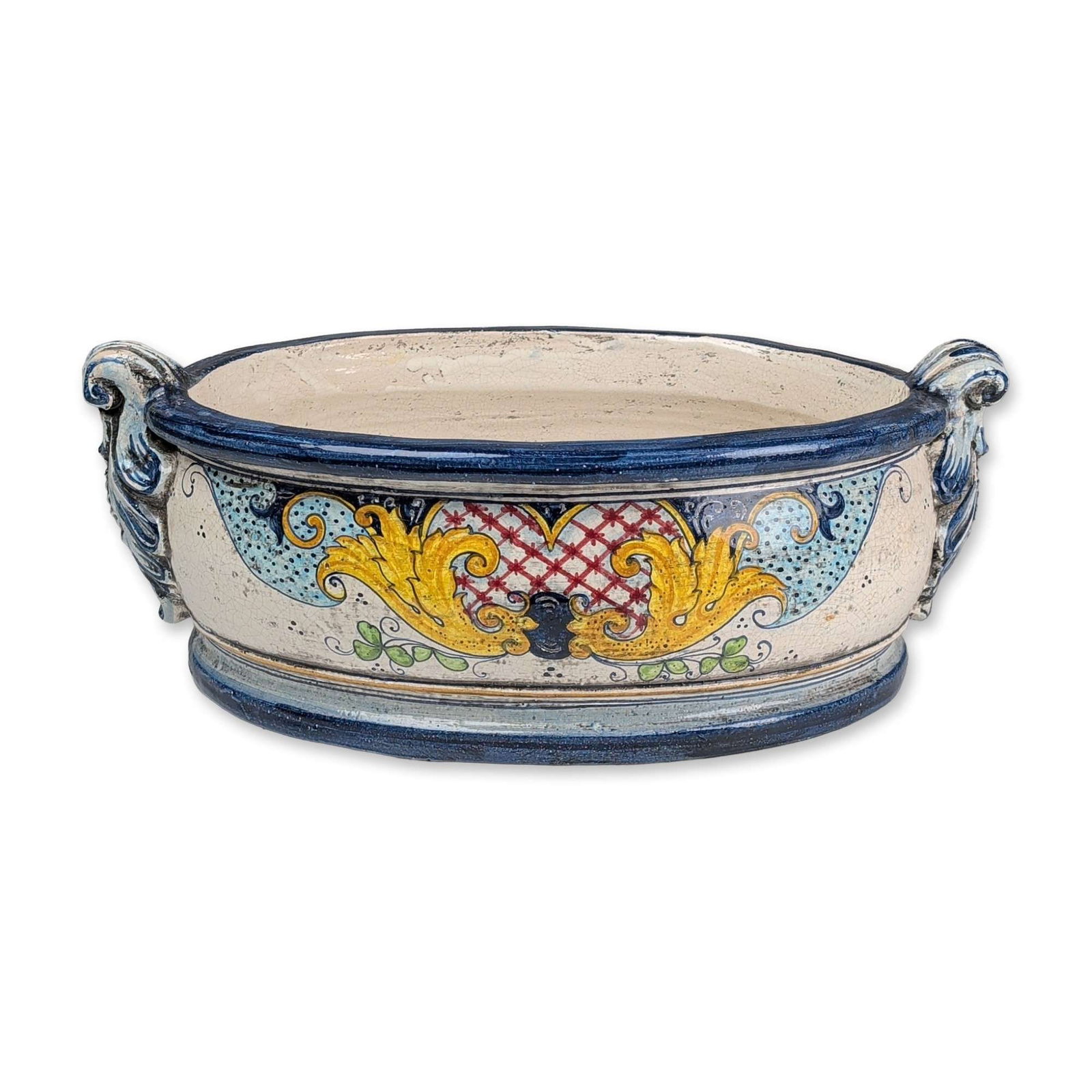 Italian Majolica Ceramic Footed Basin: Large hand-painted tin-glazed earthenware basin of oval form, featuring twin volute-scrolled handles and a stepped, molded base. The exterior is decorated in a Renaissance-revival style with yellow ac