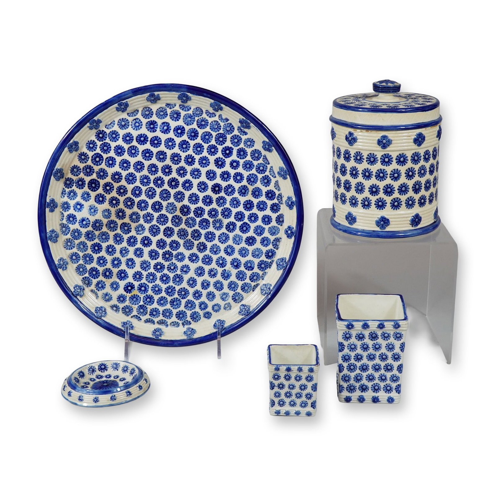 6pc Wedgwood Blue and White Rosette Tableware: This group features a distinctive relief-molded and hand-decorated pattern. The items include a large circular charger, a large cylindrical lidded canister with a reeded body, a rectangular lidded tea