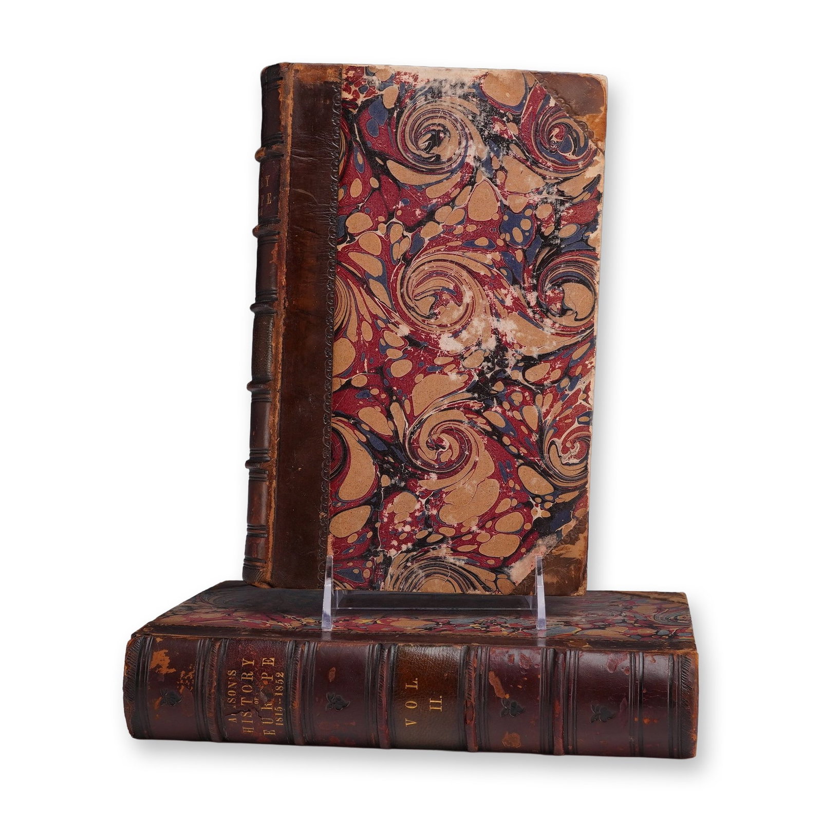 Two Sir Archibald Alison Volumes I and II History of Europe 1815 - 1852: This lot consists of two volumes of Sir Archibald Alison's History of Europe, specifically covering the period from 1815 to 1852. The set includes Volume I and Volume II, bound in half-leather with