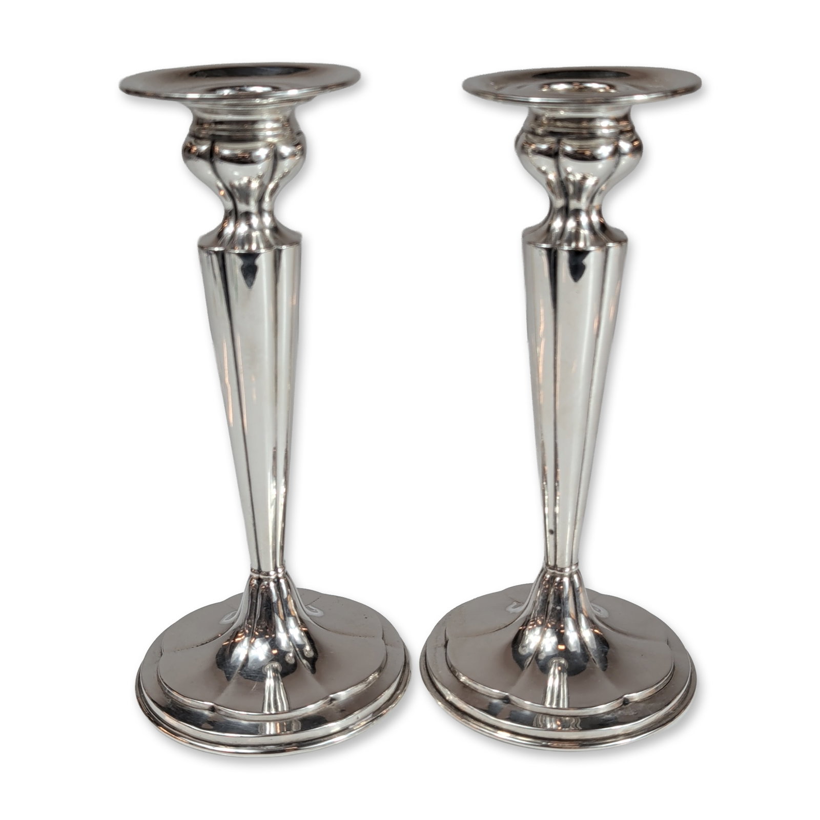 Pair of International Silver Co. Weighted Sterling Silver Candlesticks: International Silver Company. Pair of sterling silver candlesticks in model 440, featuring a classic fluted design. Each candlestick is constructed with a circular multi-stepped base, tapered fluted s