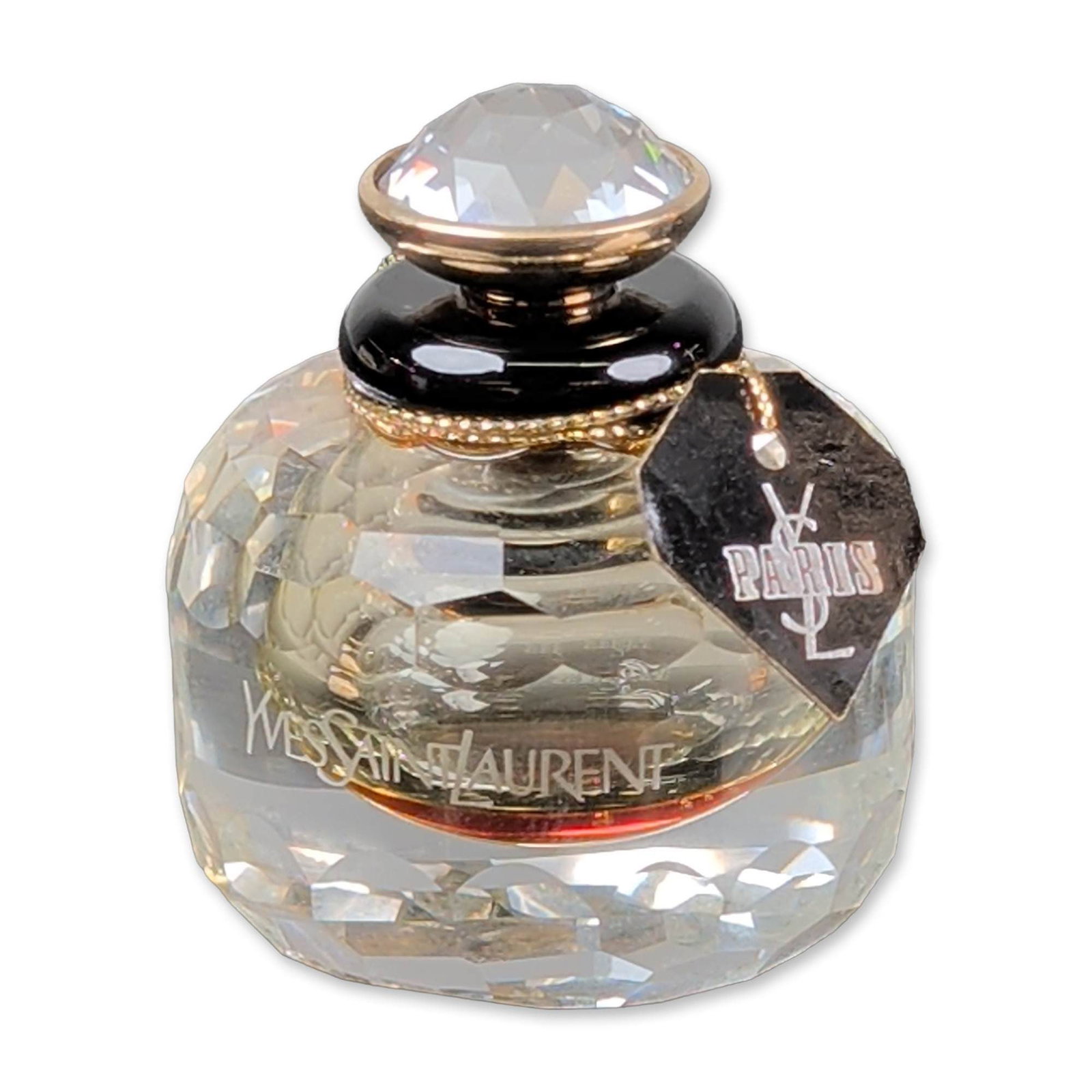 YSL Paris Parfum Limited Edition Crystal Numerotee Bottle: Yves Saint Laurent 1996 Paris parfum extrait de parfum presented in a numbered crystal edition faceted bottle. The vessel is a compressed spherical form with light-refracting facets and includes a