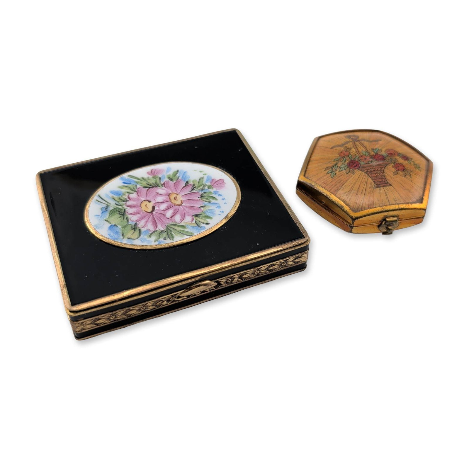 Two Vintage Houbigant and Bliss Powder Compacts: Two vintage powder compacts including one Houbigant and one styled by Bliss example. The Houbigant compact is hexagonal gold-tone metal, featuring a lid with a hand-painted floral basket motif on a wo
