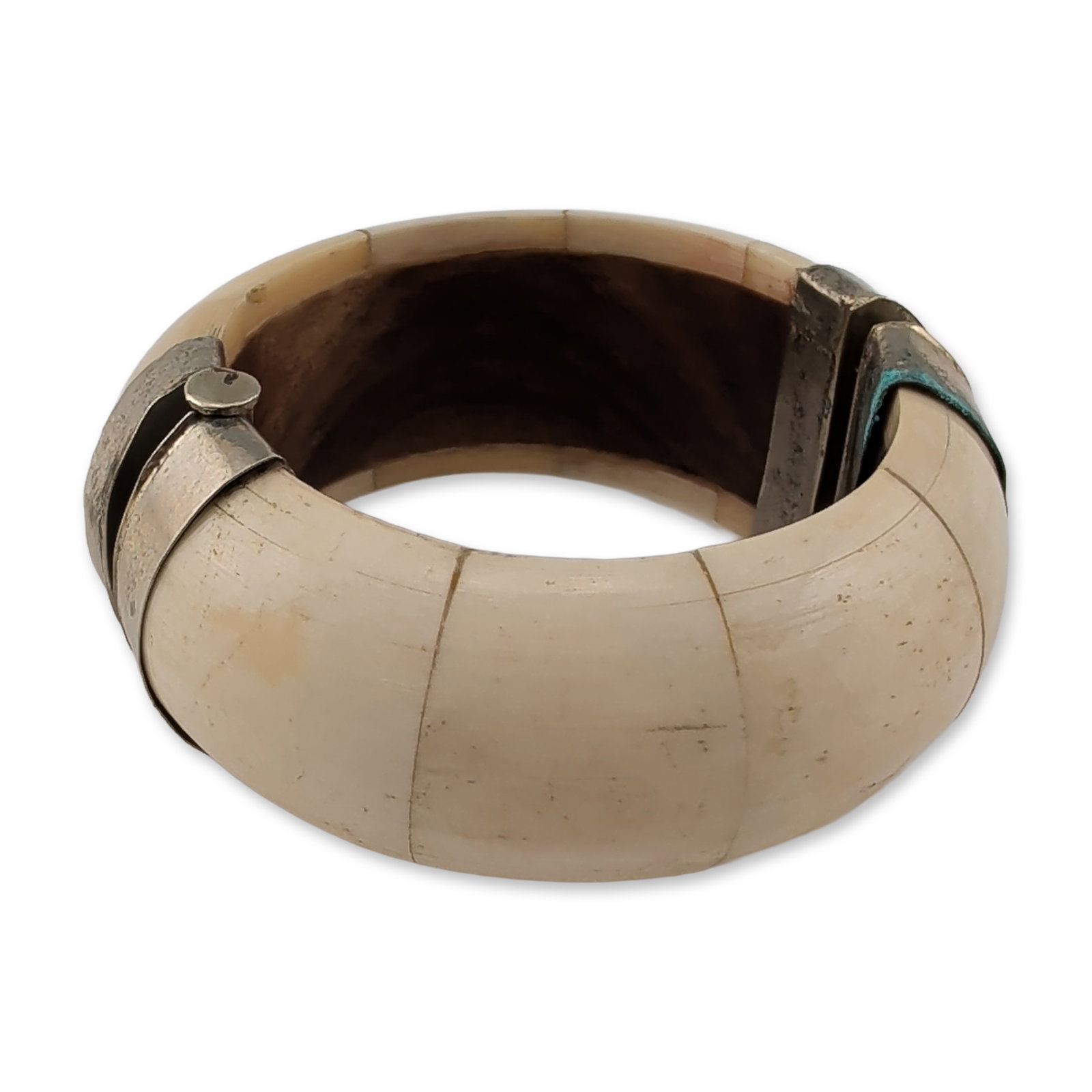 Bone and Metal Hinged Bangle: Vintage hinged bangle bracelet featuring segmented natural bone inlays over wood. The cream-colored segments exhibit natural graining and surface texture, set into a silver-toned metal mounting. The b