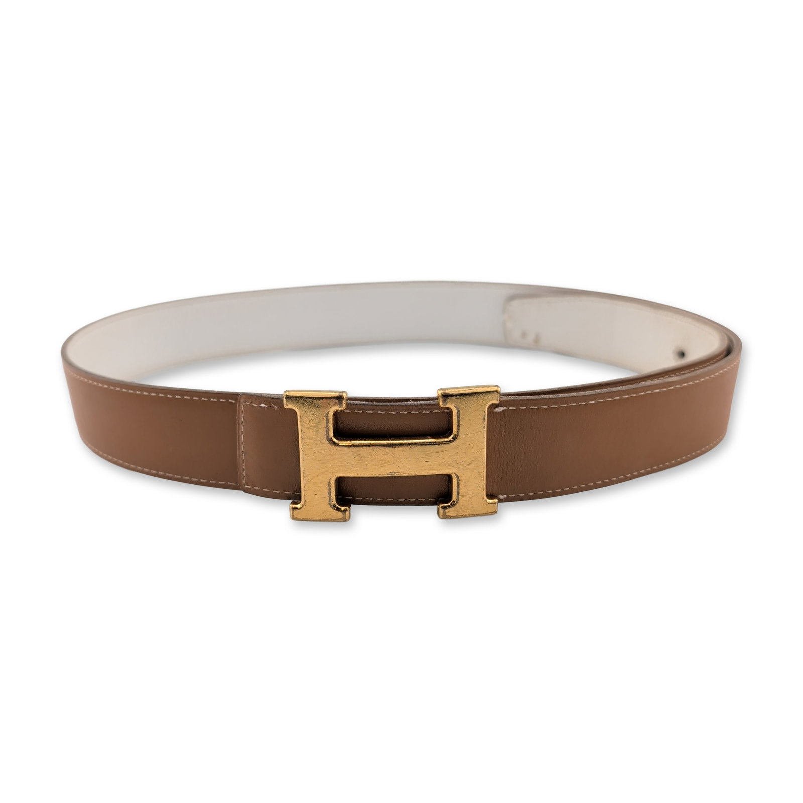 Hermes Paris Reversible Leather Constance Belt: Hermes reversible belt in tan smooth leather and cream pebbled leather, featuring a gold-tone metal H buckle. The interior strap is incised with Hermes Paris Made in France, followed by a square K,