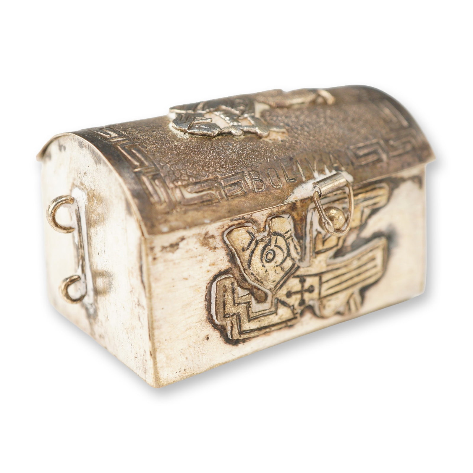 Bolivian 925 Sterling Silver Miniature Trunk Form Trinket Box: This miniature 925 sterling silver trinket box is designed in the form of a treasure chest or trunk. The item features a domed lid and is decorated with traditional Pre-Columbian motifs characteristic