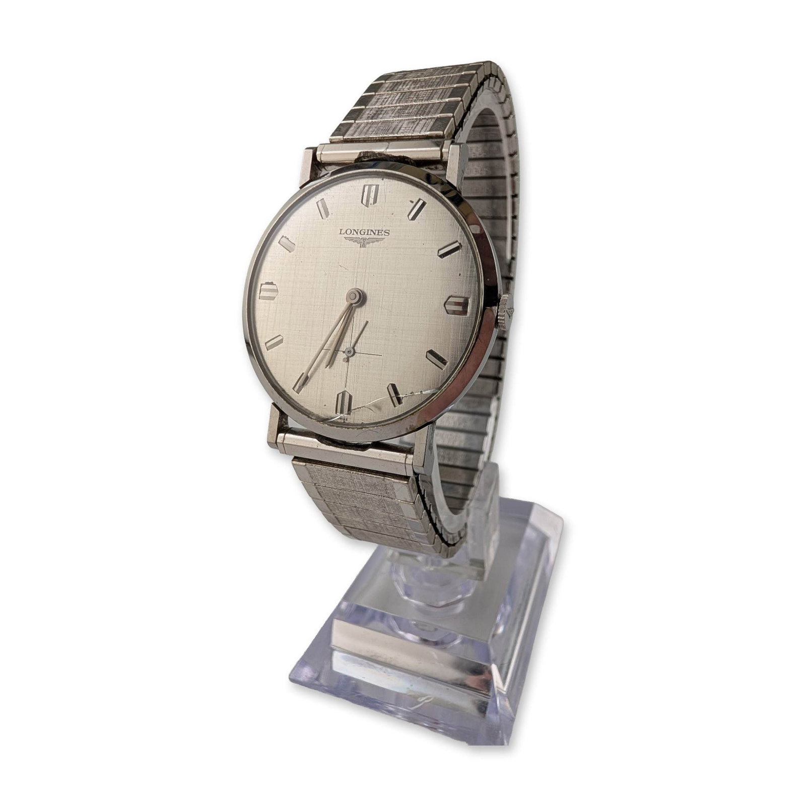 Longines Stainless Steel Linen Dial Dress Watch: Longines mid-century manual wind dress watch in stainless steel, featuring a silver-tone linen-textured dial with applied hour markers and sub-seconds at the six o'clock position. The dial is signed w