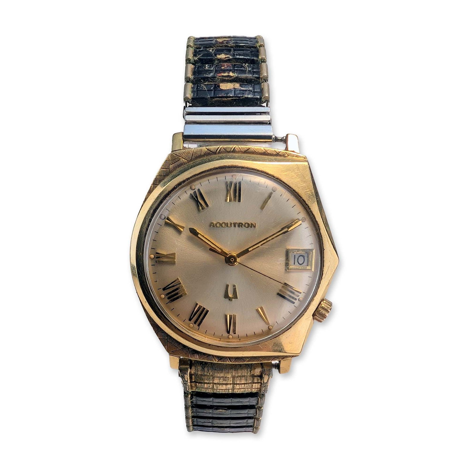 Bulova Accutron Wristwatch with 14kt Gold Case: Bulova, 1967. Accutron tuning fork wristwatch in a solid 14kt yellow gold asymmetric case, featuring a champagne sunburst dial with applied gold-tone Roman numeral hour markers and a date window at th