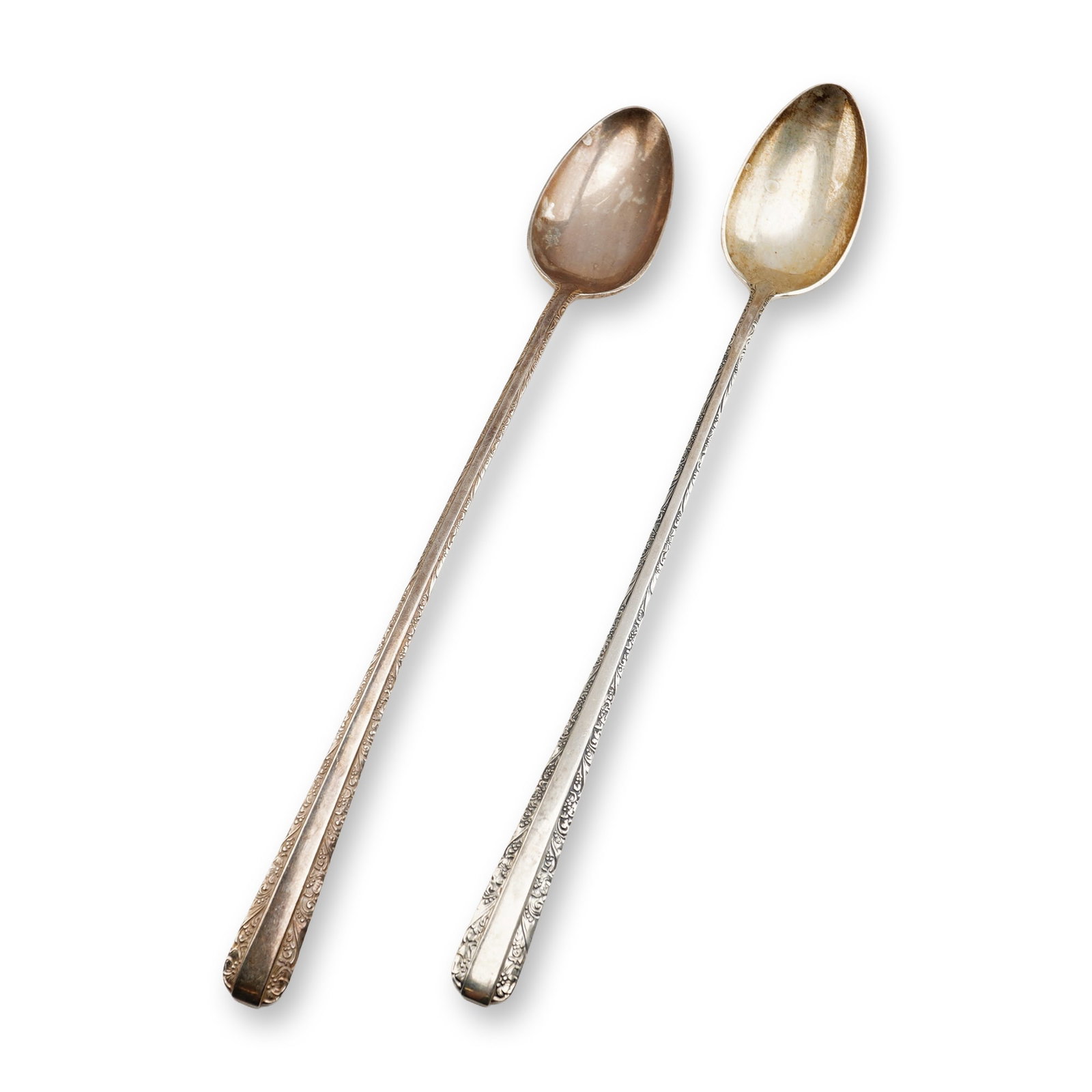 2pc Towle Candlelight Sterling Silver Iced Tea Spoons: Two iced tea spoons crafted in the Candlelight pattern by Towle Silversmiths. The spoons are constructed of sterling silver and feature long, tapering handles. The decorative motif consists of scrolli