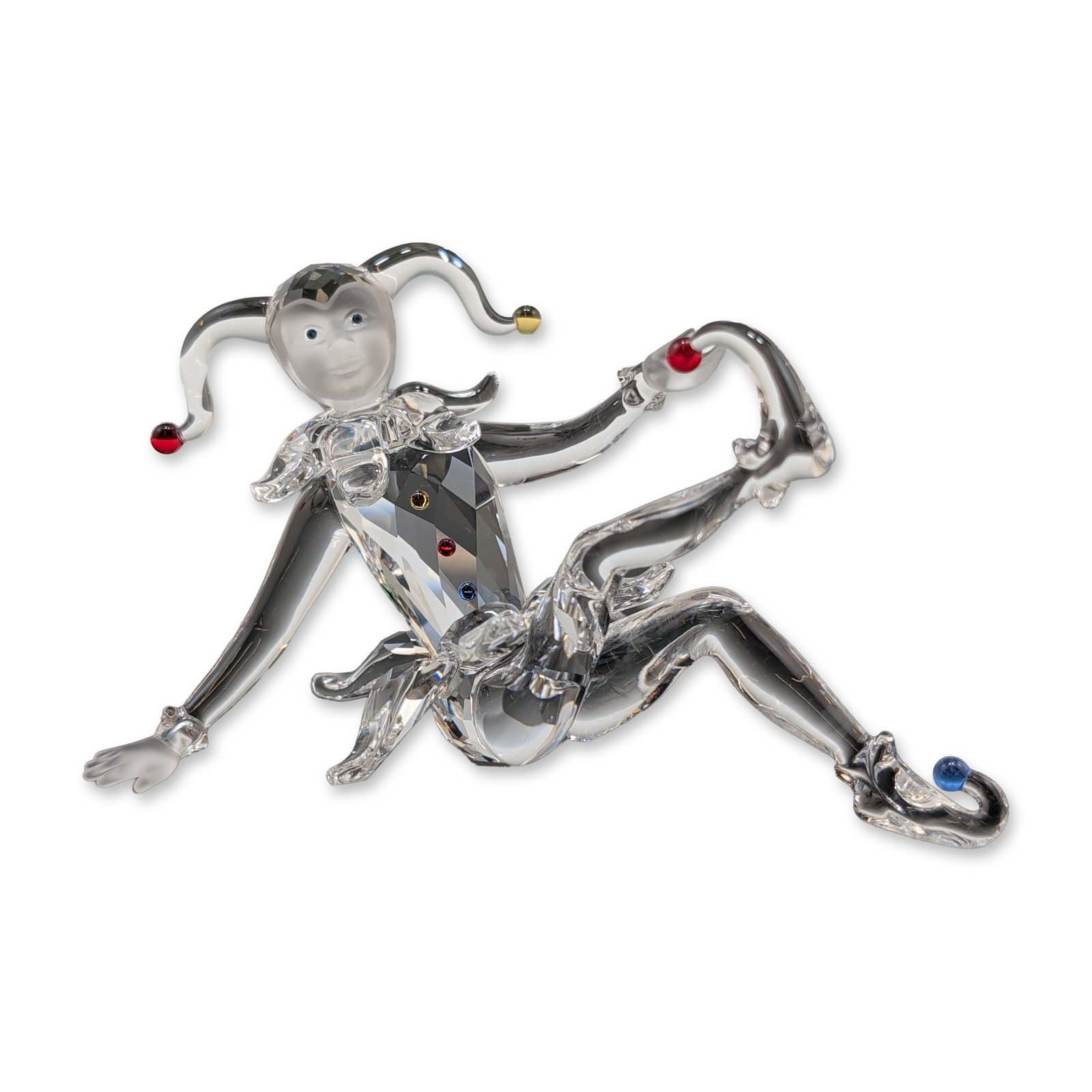 Swarovski Crystal Figurine, Jester: Swarovski crystal figurine titled Jester, a piece from the Fairy Tales theme group. Designed by Edith Mair, the figure is constructed from clear, faceted crystal in a dynamic acrobatic pose. Features 