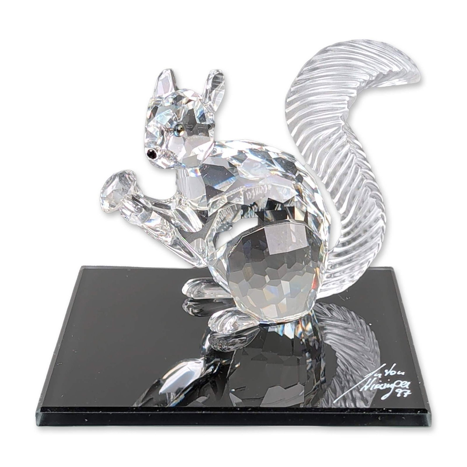 Swarovski SCS 10th Anniversary Crystal Squirrel Figurine Signed: Swarovski Crystal Society (SCS) 10th anniversary commemorative squirrel figurine, designed by Anton Hirzinger. The seated figure is constructed from faceted clear lead crystal with dark crystal eyes a
