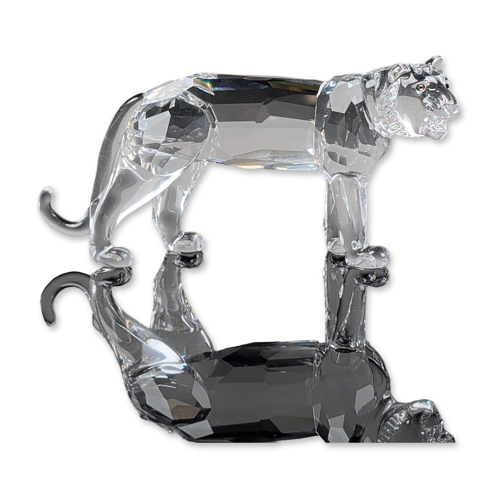 Swarovski Silver Crystal Figurine, Tiger: Swarovski Silver Crystal. Tiger figurine in faceted lead crystal, designed by Michael Stamey, depicting a large cat in a walking pose. The piece features a faceted body with smooth molded crystal for 