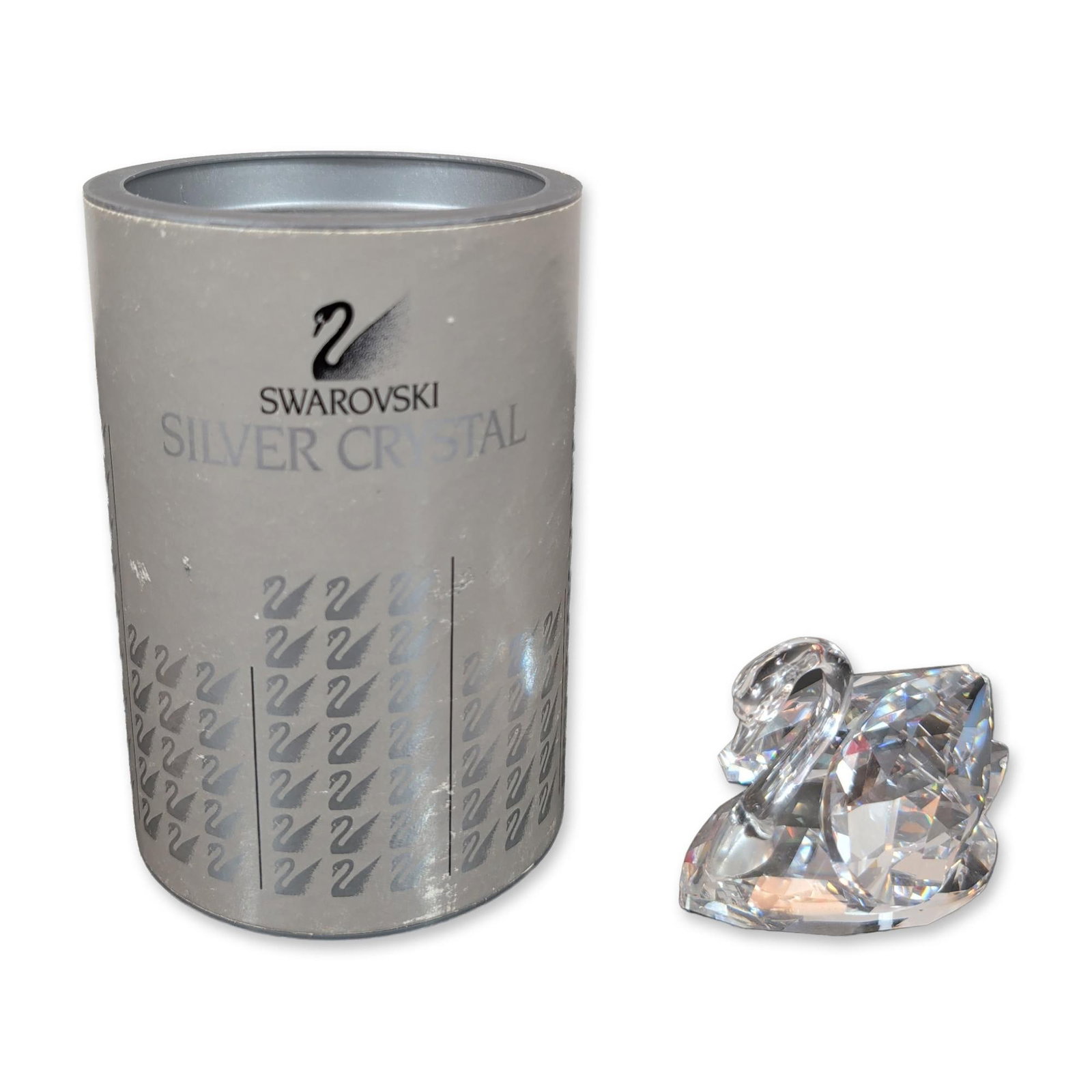 Swarovski Silver Crystal Swan Figurine: Stylized swan figurine from the Silver Crystal collection, crafted in faceted lead crystal with a smooth, curved neck and head. The base displays a laser-etched Swarovski swan logo and Swarovski signa
