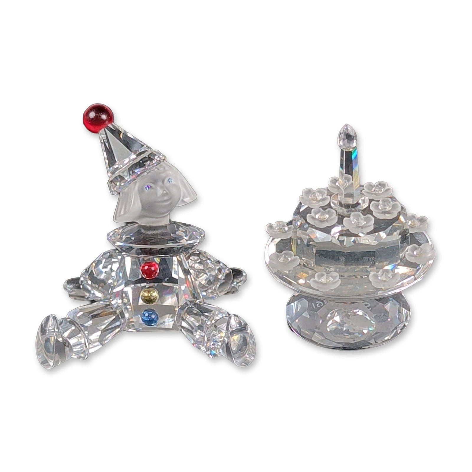 2pc Swarovski Silver Crystal Figurines, Cake and Puppet: Two Silver Crystal figurines including the 1992 SCS 5th Anniversary Happy Birthday cake and the Puppet figurine from the When We Were Young collection. The birthday cake is constructed from faceted le