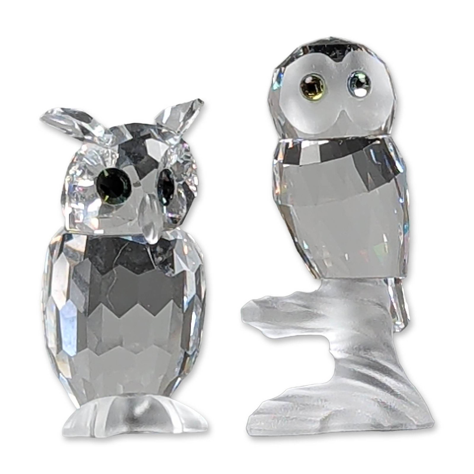 2pc Swarovski Silver Crystal Owl Figurines: Two faceted lead crystal figurines from the Swarovski Silver Crystal collection. The owls features faceted bodies and smooth rounded head with large colored crystal eyes. One base bears an incised Ant