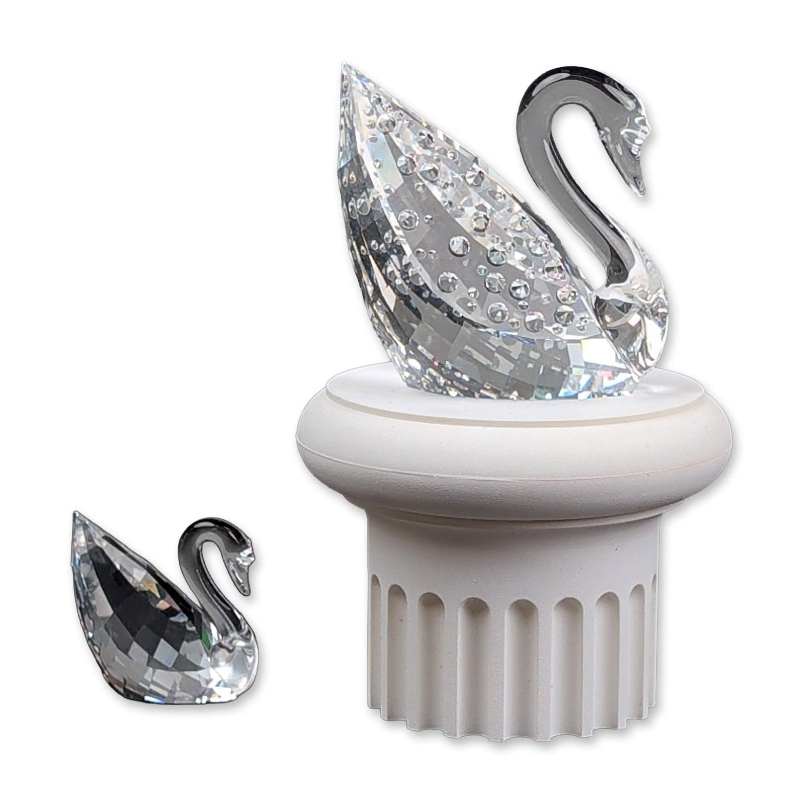 3pc Swarovski Centenary Faceted Crystal Swan Figurines with Base: Swarovski centenary commemorative set featuring a large lead crystal swan with a faceted body pave-set with chaton crystals on the wings. The set includes a smaller faceted crystal swan and a white fl