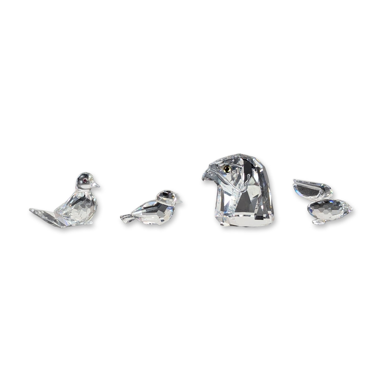 4pc Swarovski Silver Crystal Bird Themed Figurines: Swarovski Silver Crystal. Collection of figurines in faceted lead crystal, featuring an eagle head with polychrome eyes, a sparrow, a fan-tailed dove, and a pelican signed and dated. All pieces are ma