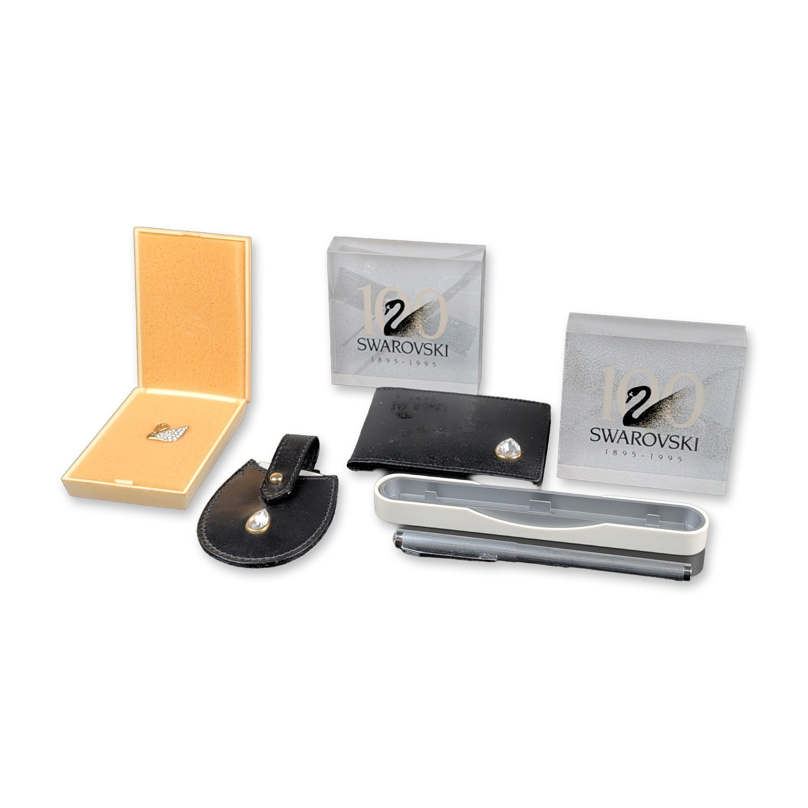 6pc Swarovski Centennial and SCS Membership Gifts: Swarovski. Collection of commemorative and membership accessories including jewelry, stationery, and display items. The group features a gold-toned swan brooch with pave-set clear faceted crystals in 