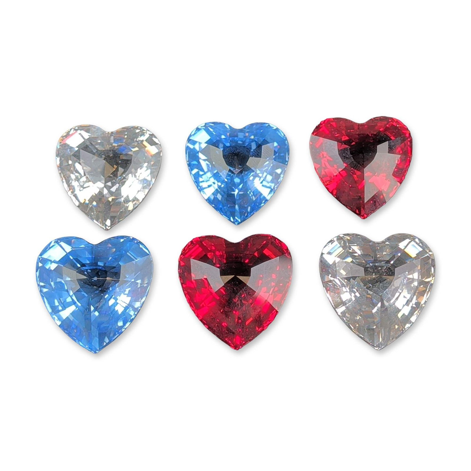 6pc Swarovski Crystal Society (SCS) Crystal Hearts Paperweights: Swarovski Crystal Society (SCS). Group of six faceted heart paperweights that appear to be lead crystal, including translucent red, translucent blue, and colorless examples. Each piece features a symm