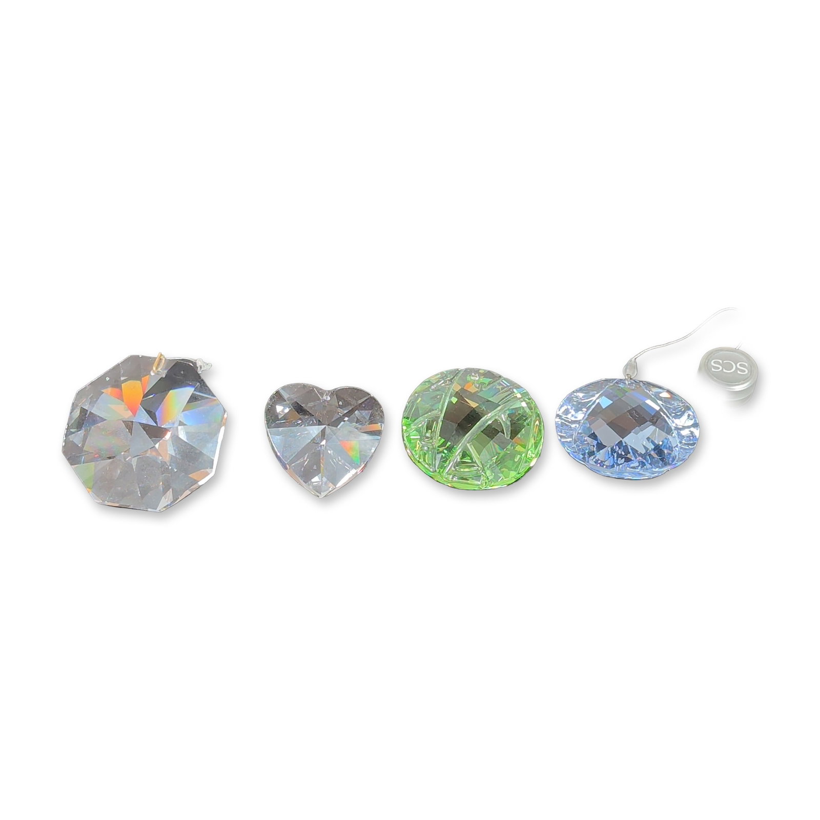 5pc Swarovski Faceted Lead Crystal Ornaments: Swarovski collection of faceted lead crystal decorative objects, including one large clear octagonal crystal with an integrated metal suspension ring, a clear heart-shaped crystal, a green faceted rou