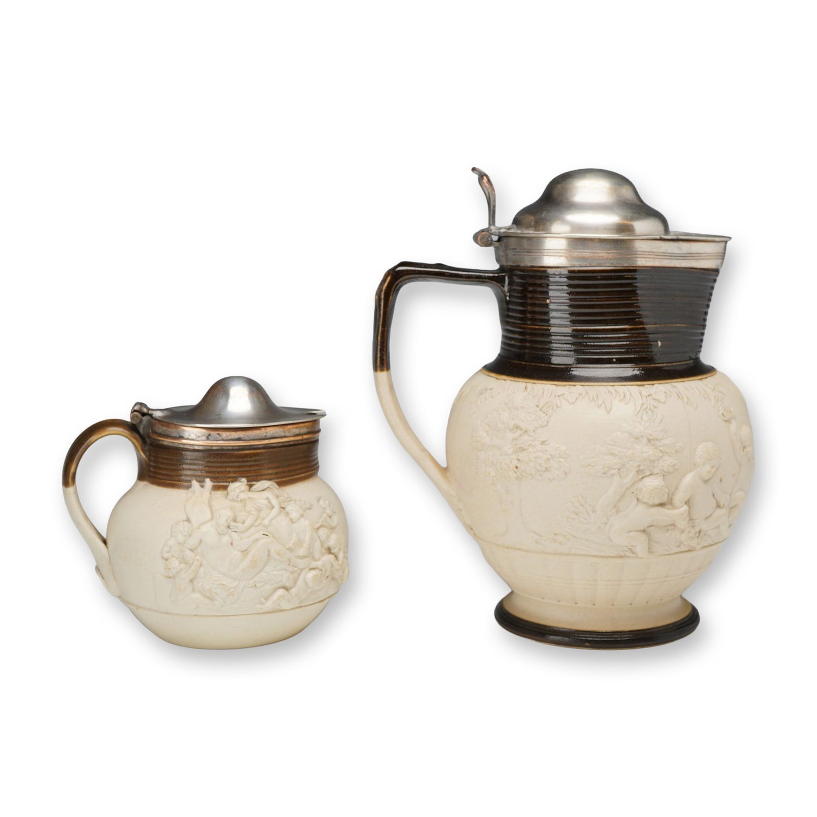 2pc Adams Stoneware Pitchers with Silver-Plated Tops: This pair of Adams stoneware vessels consists of a larger jug and a smaller lidded tankard or pitcher. Each piece is crafted from an off-white stoneware body featuring a smear-glazed finish. The mid-s