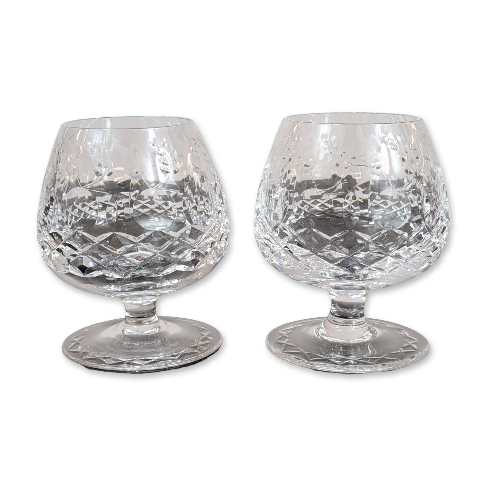 Pair of Rogaska Gallia Crystal Brandy Snifters: Rogaska. Pair of brandy snifters in lead crystal, decorated in the Gallia pattern. The design consists of a lower bowl with deep-cut criss-cross diamond facets and an upper section featuring an acid-e
