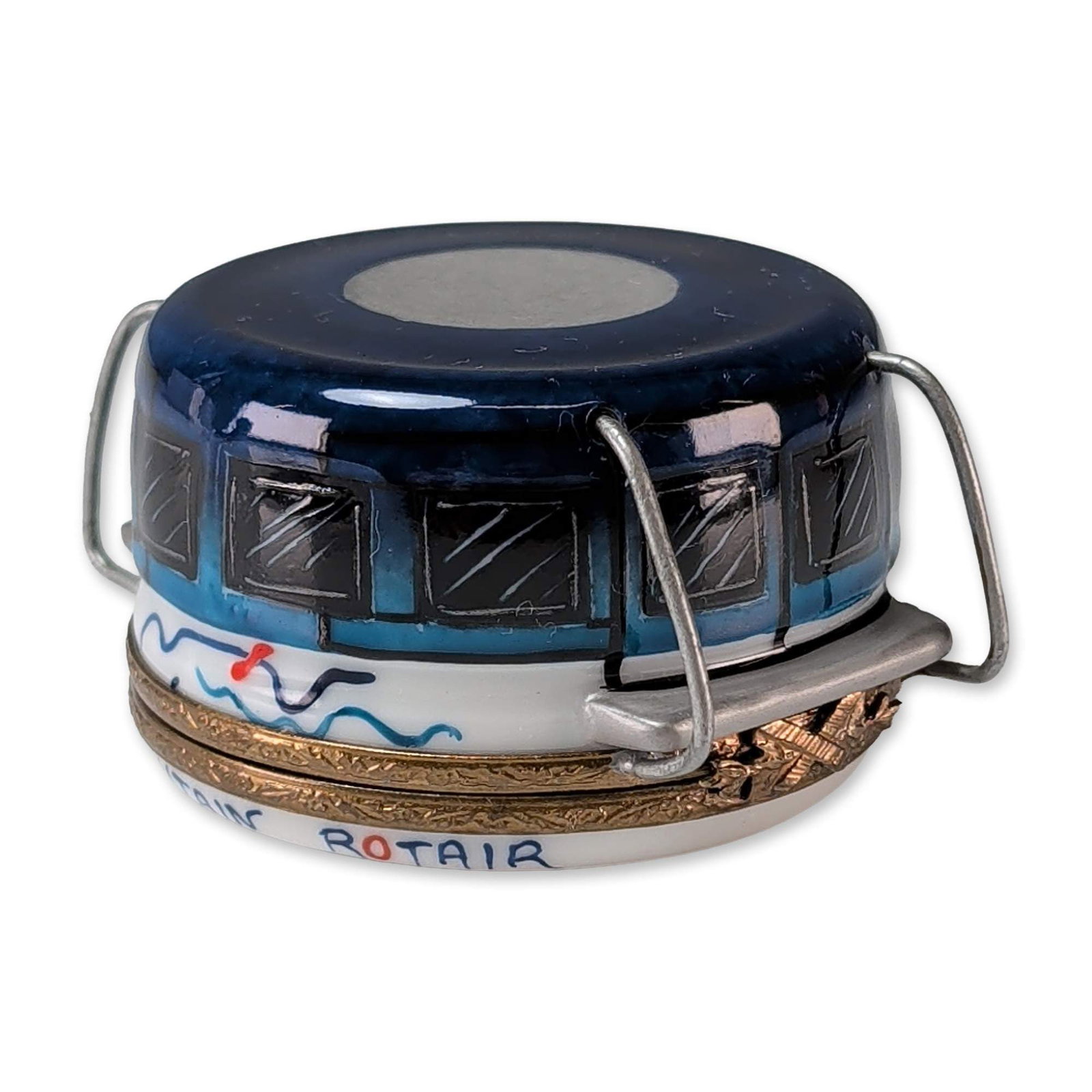 Limoges Porcelain Table Mountain Rotair Trinket Box: Limoges, France, hand-painted porcelain hinged trinket box modeled in the form of a Table Mountain Rotair cable car. The exterior is decorated in shades of blue, white, and black, with the base rim in