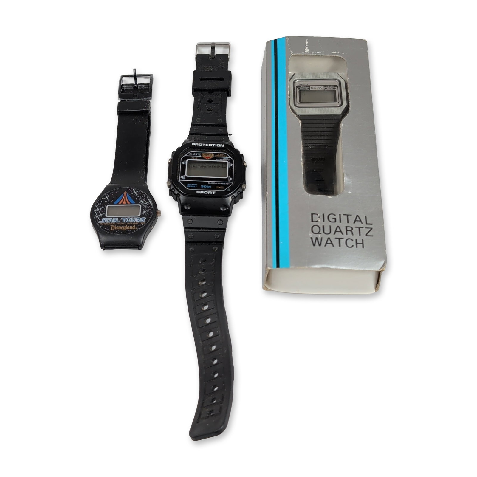 3pc Vintage Digital Wristwatches: Trio of vintage digital wristwatches. The lot includes a Braddex digital quartz watch in its original silver-tone cardstock box, featuring a silver-tone resin case and black ribbed strap. All three wa