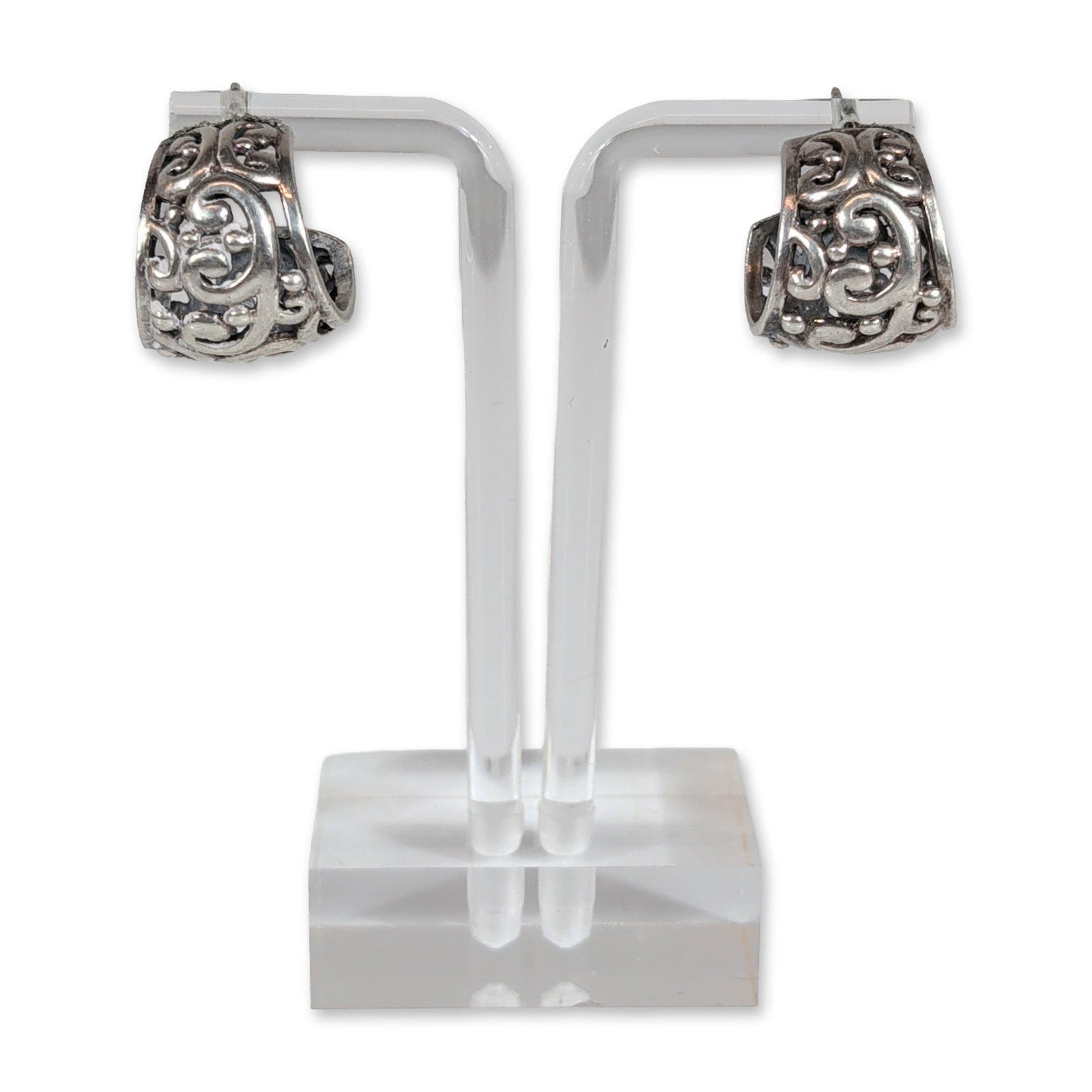 Pair of Sterling Silver Filigree J-Hoop Earrings: Pair of sterling silver earrings in a J-hoop silhouette, featuring cast openwork filigree and scrollwork decoration with spherical accents. The design incorporates recessed oxidized areas to provide v