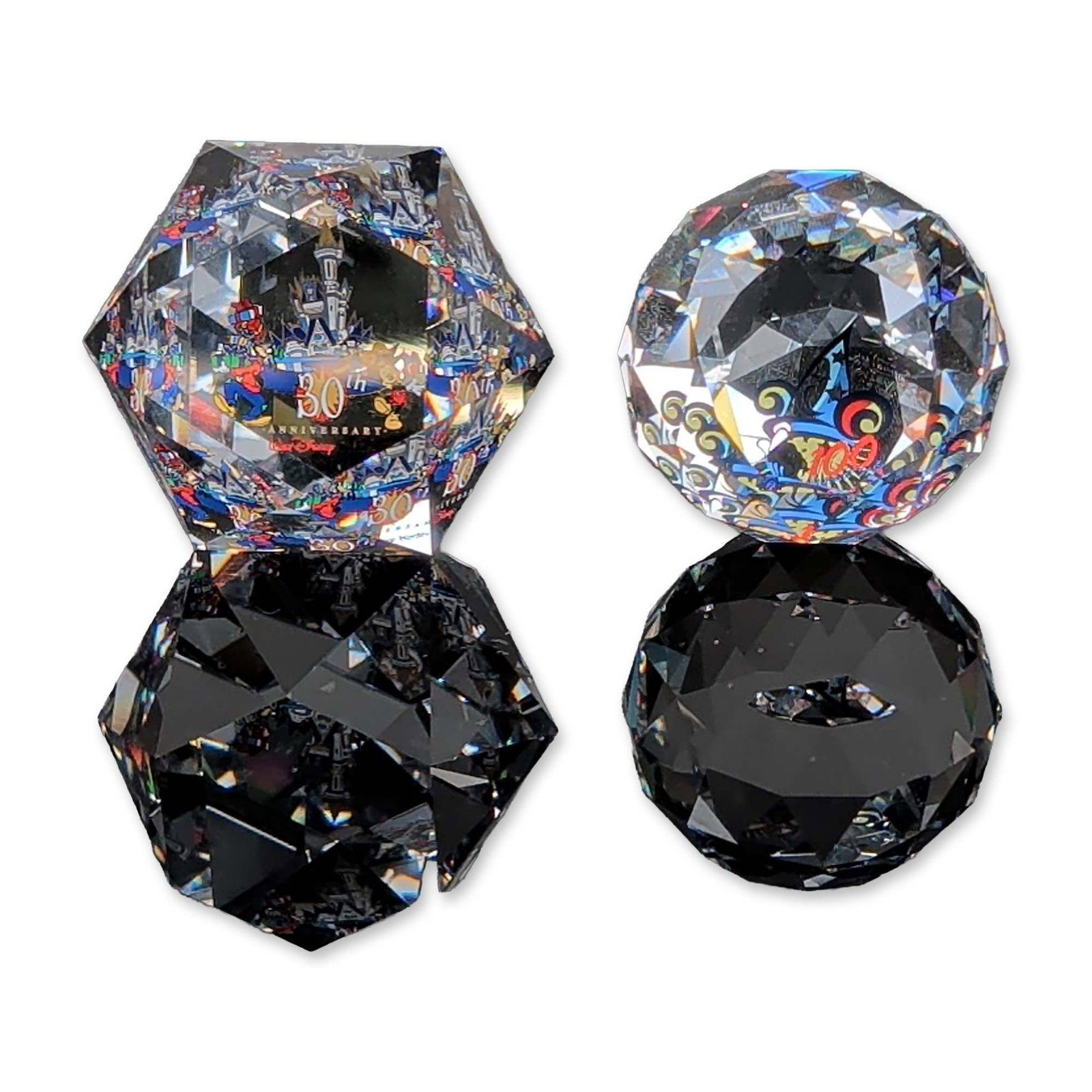2pc Arribas Brothers Swarovski Disney Crystal Paperweights, 30th & 100th Anniversary: Arribas Brothers and Swarovski Disney commemorative faceted lead crystal paperweights, celebrating the Walt Disney World 30th Anniversary and Disney 100 Years of Wonder milestones. The hexagonal form 