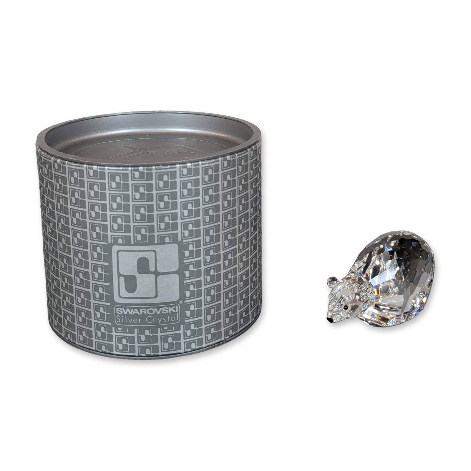 Swarovski Silver Crystal Polar Bear Figurine: Swarovski Polar bear figurine in faceted lead crystal, featuring small black crystal accents for the eyes and nose. Original cylindrical storage container included with Swarovski Silver Crystal labeli