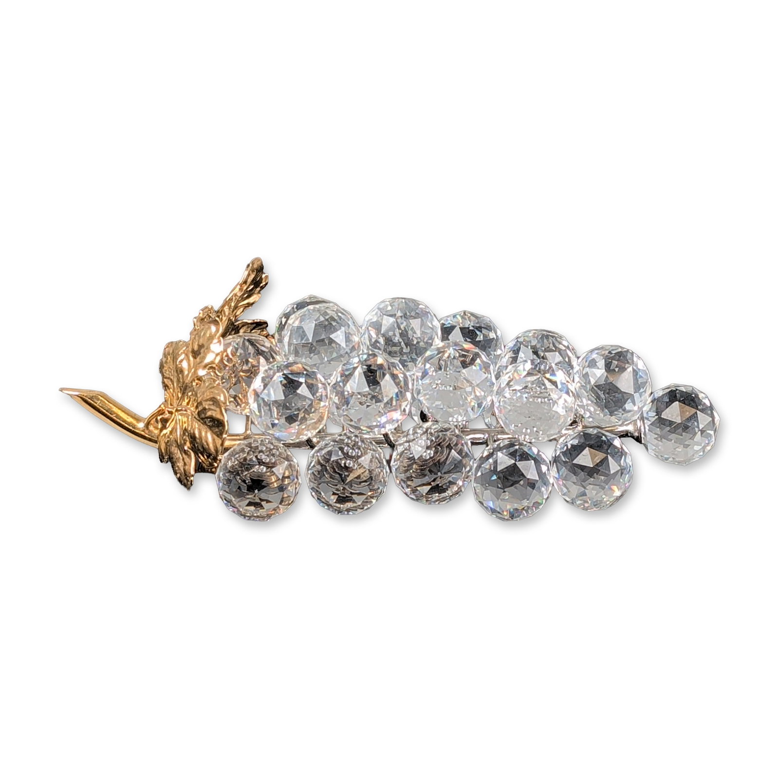 Swarovski Crystal and Gold Finish Figurine, Grapes: Swarovski figural brooch in a grape cluster motif, featuring 23 faceted clear lead crystal spheres. The decorative leaves, coiled tendrils, and stem tip are finished in gold-toned metal, while the cen