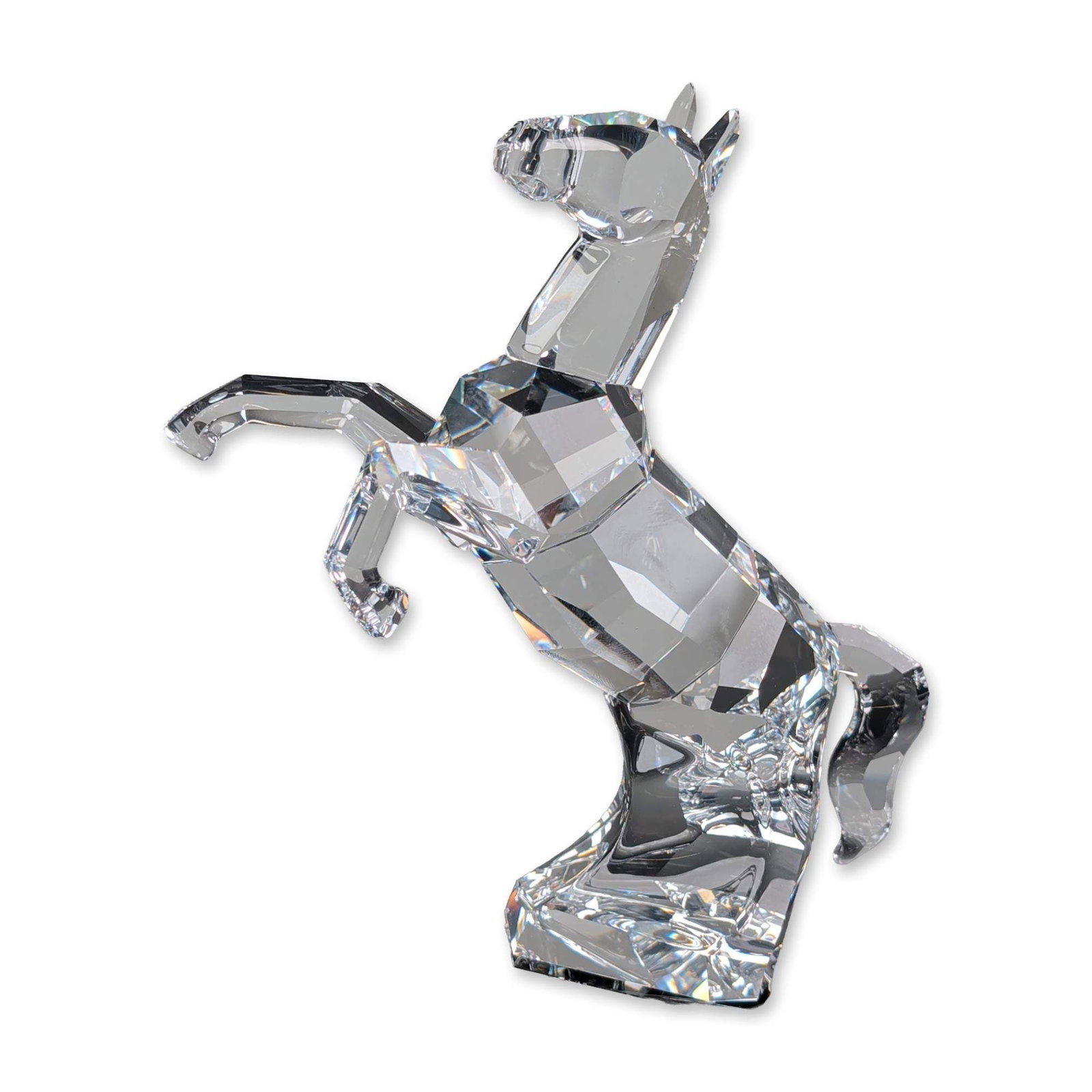 Swarovski Faceted Clear Crystal Horse Figurine, The Symbols: Swarovski crystal stallion figurine in a dynamic rearing pose. The piece is crafted from faceted clear lead crystal with geometric surfaces designed for light refraction. Accompanied by the original b