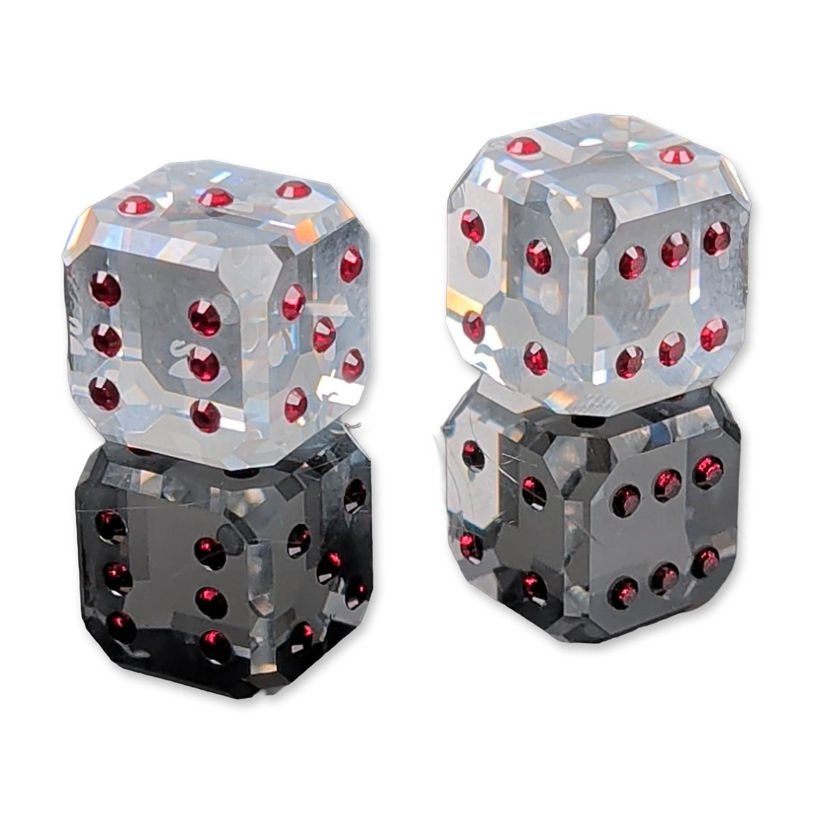 2pc Swarovski Crystal Red Pip Dice: Swarovski. Pair of dice in faceted clear lead crystal, featuring inset red crystal chaton pips. Each die is crafted with multiple geometric facets and bears a discreet etched swan logo. The lot includ