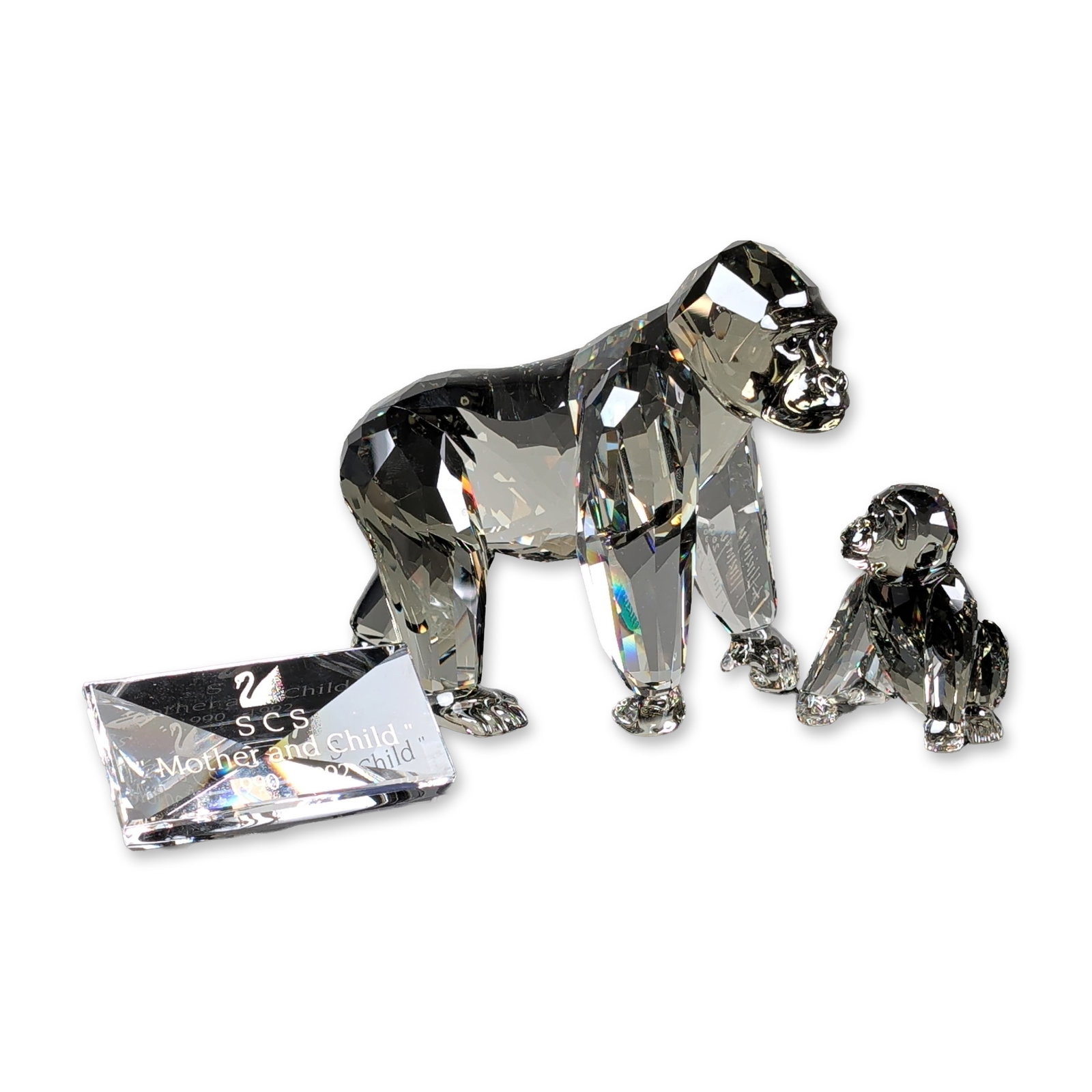 3pc Swarovski Crystal 2009 Annual Edition Figurine, Gorillas Mother and Cub plus Title Plaque: Swarovski 2009 SCS Annual Edition Gorillas from the Endangered Wildlife trilogy. Two faceted crystal figurines depicting a mother gorilla and an infant in Black Diamond and clear tones. Designed by An