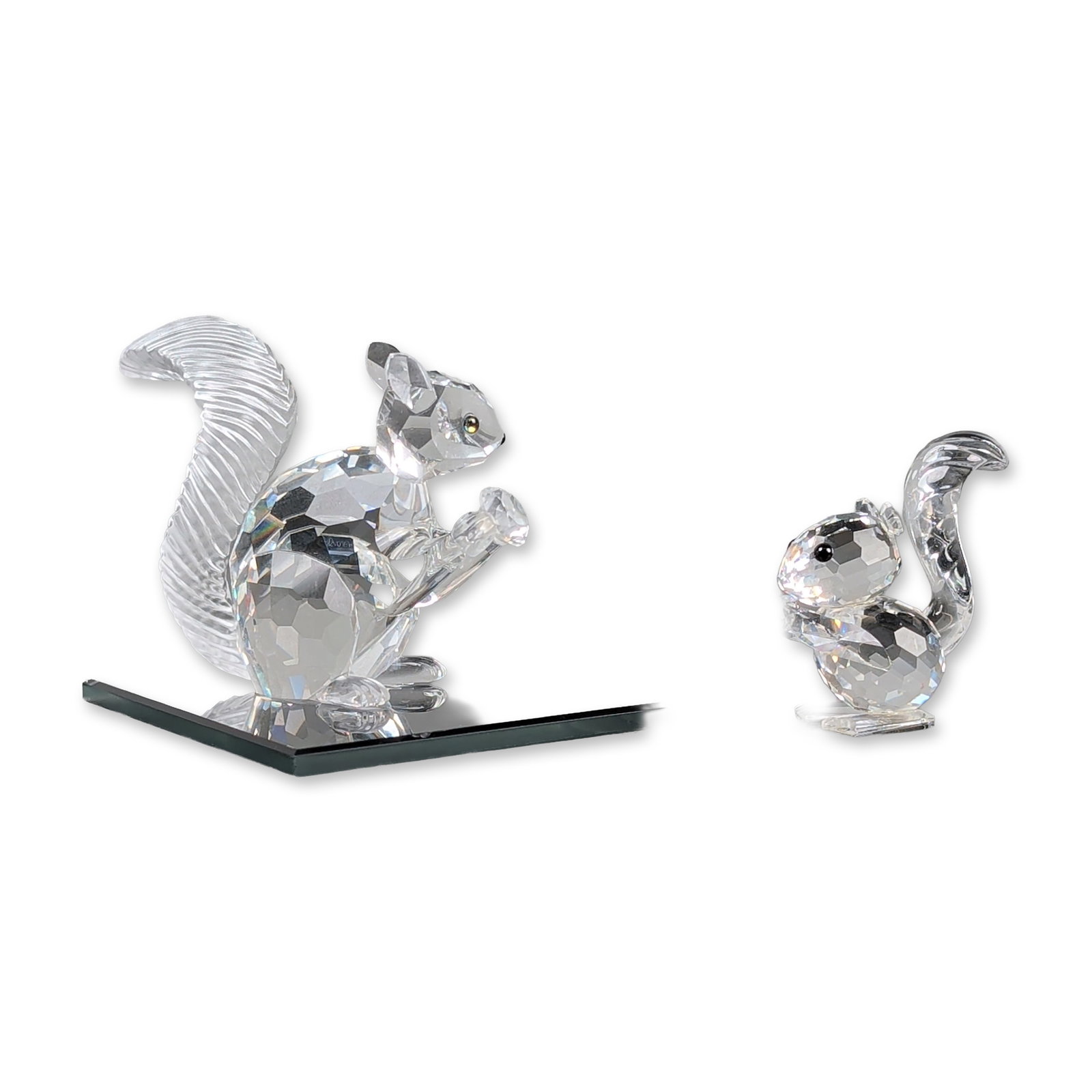 3pc Swarovski Crystal Squirrel Figurines with Base: Two Swarovski faceted lead crystal figurines including the 1997 SCS Annual Edition Squirrel and a small squirrel. The squirrel is part of the Fabulous Creatures trilogy and features a faceted body wit