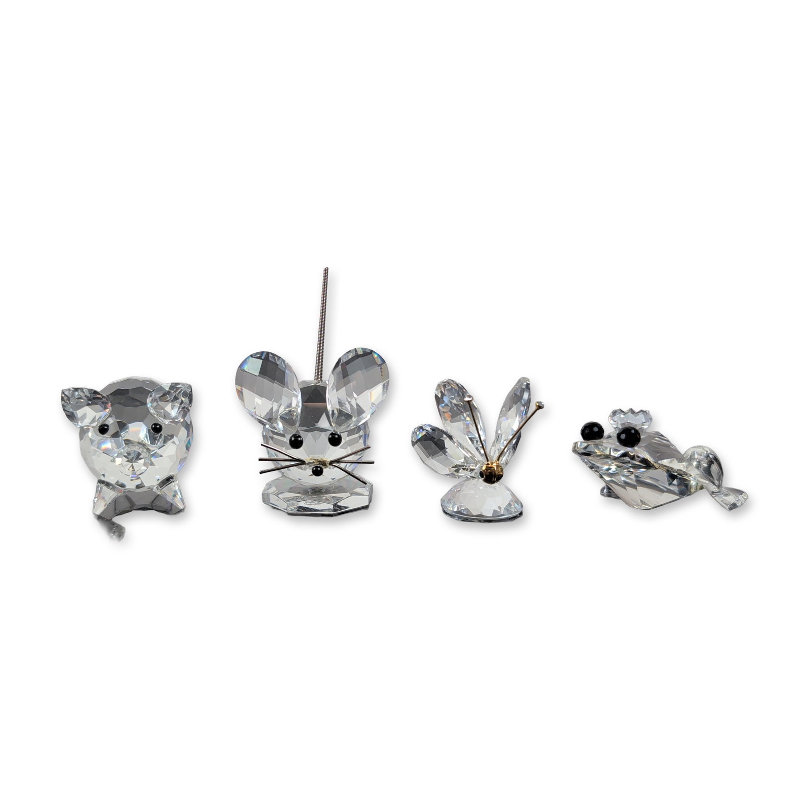 4pc Swarovski Crystal Miniature Animal Collection: A dazzling collection of Swarovski crystal animal figurines crafted in faceted lead crystal, each adorned with charming details like black bead eyes and elegant metal accents. The group includes a pig