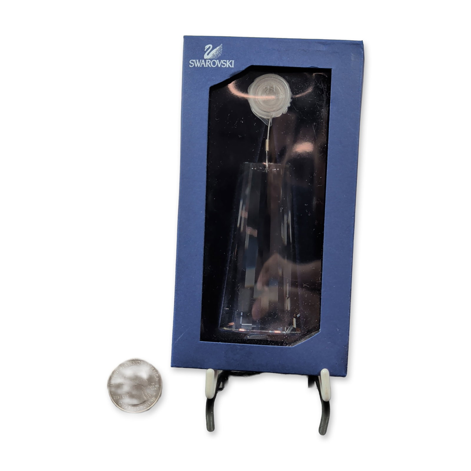 Swarovski Clear Crystal Faceted Wing Ornament: This Swarovski clear crystal multi-faceted suncatcher wing ornament dazzles with its brilliant sparkle. The crystal is suspended by a metal wire from a circular clear plastic mounting disk, and it com