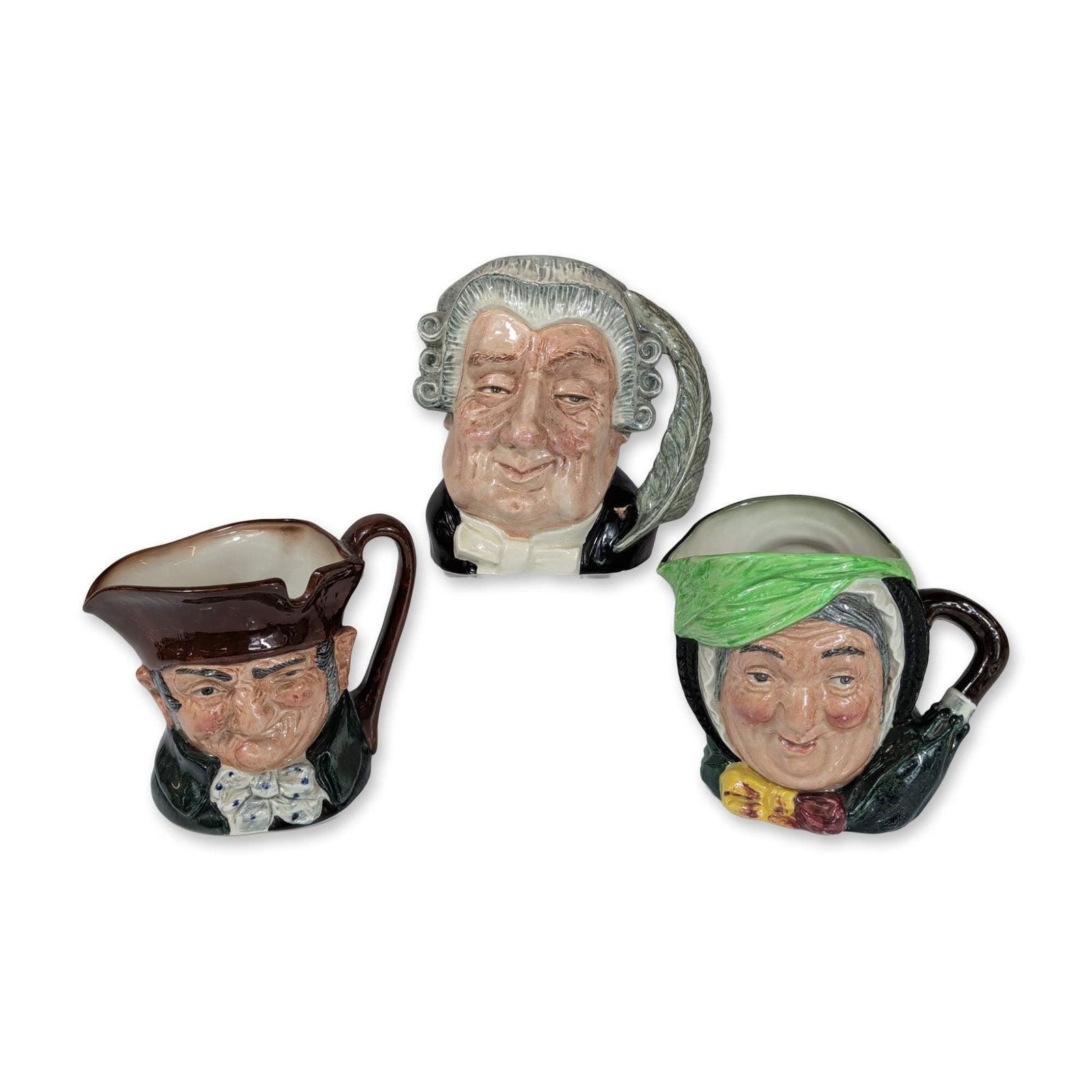 3pc Royal Doulton Ceramic Character Jugs: Royal Doulton, England. Group of three glazed earthenware character jugs, including The Lawyer (D6498), Sairey Gamp (D5451), and Old Charley (D6420). The Lawyer, dated 1958, features a judicial wig an