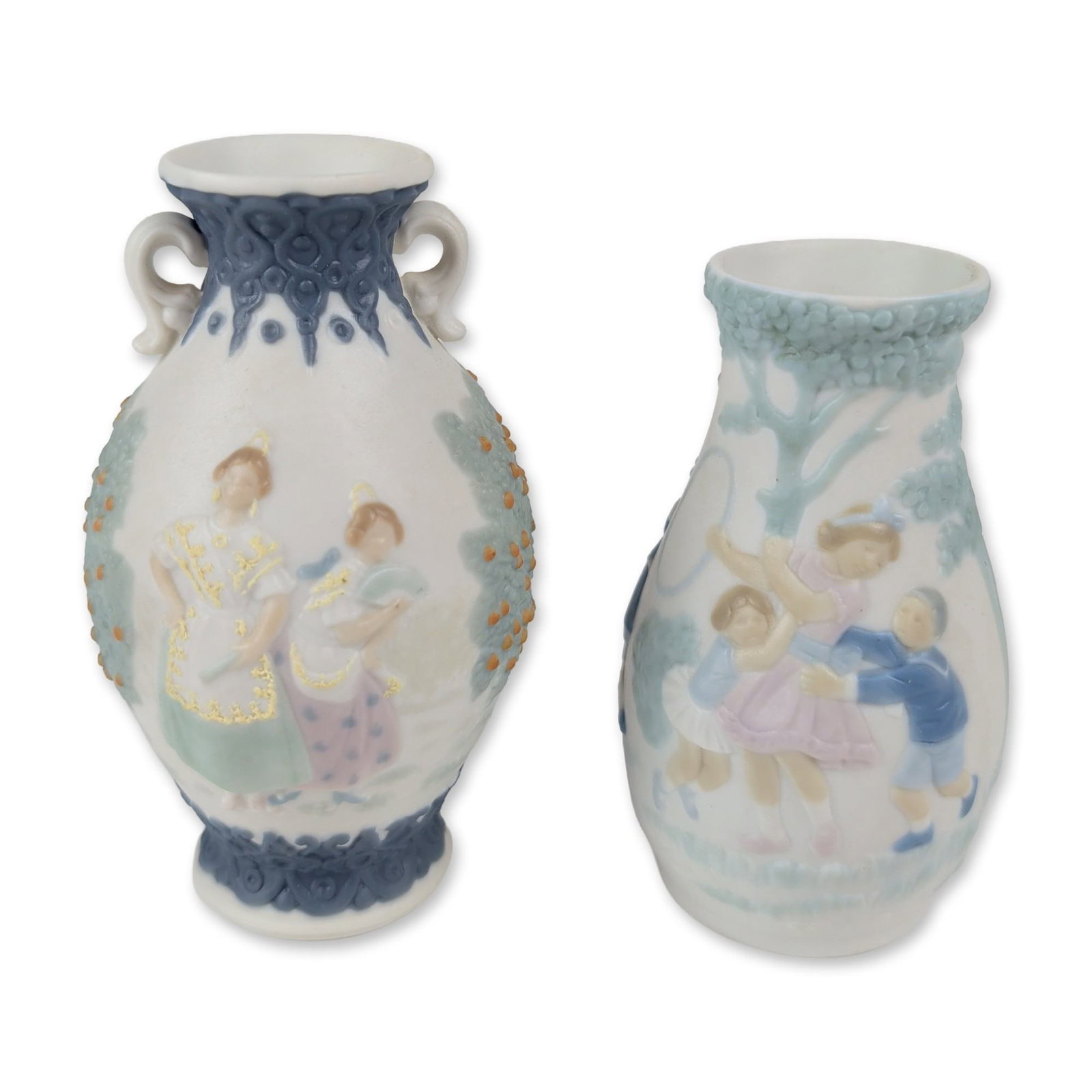 2pc Lladro Miniature Porcelain Vases: Lladro, Spain. Two miniature vases from the Coleccion Miniaturas in matte porcelain. The first known as Mini Flor (model 5258), an ovoid vase featuring a relief scene of two children playing near a tr