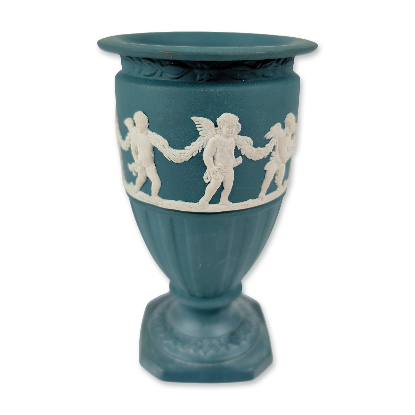 Wedgwood Spruce Green Jasperware Footed Urn: Wedgwood, England. Jasperware footed urn vase in spruce green with white bas-relief decoration, featuring a central frieze of three cherubs holding a floral garland in the Eros Laurel pattern. The ves