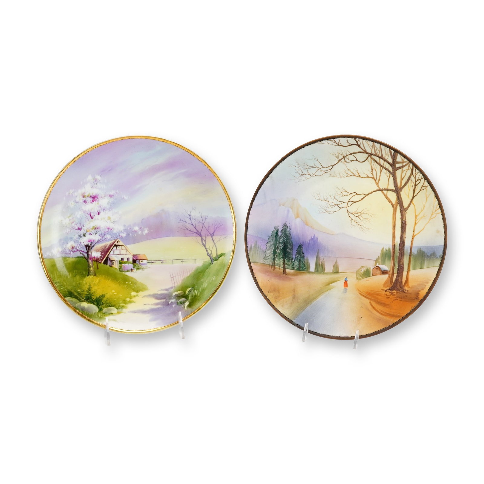 2pc Hand-Painted Nippon Porcelain Wall Plates: This pair of hand-painted Nippon porcelain wall plates dates from the Morimura Brothers era, approximately 1891 to 1921. Each plate features a distinct, unique scenic landscape. One plate depicts a ve