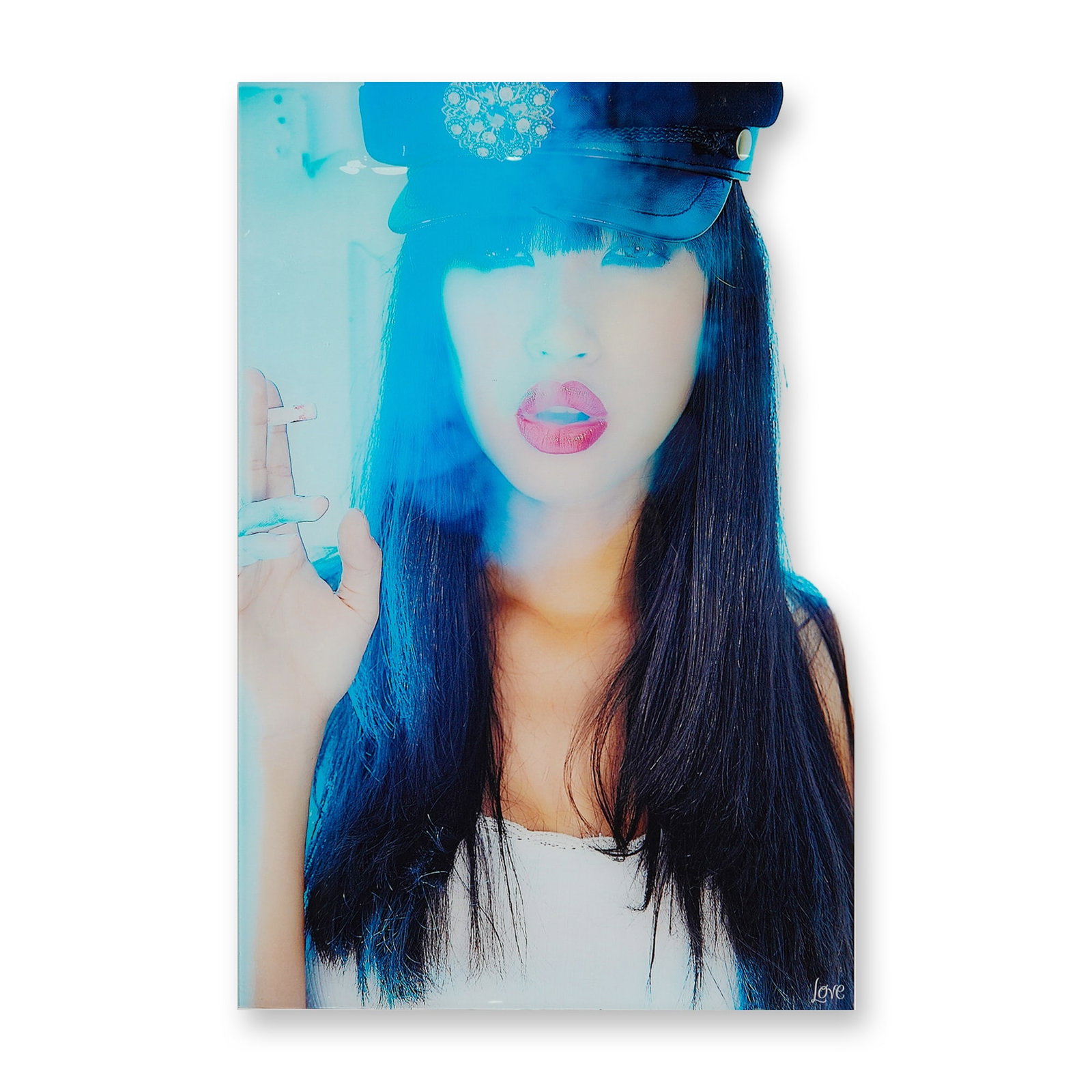 A Contemporary Photographic Print of a Woman in a Peaked Cap: This contemporary photographic print is produced on a rigid substrate, likely acrylic or metal. The composition depicts a stylized portrait of a woman with long dark hair wearing a black peaked cap wi