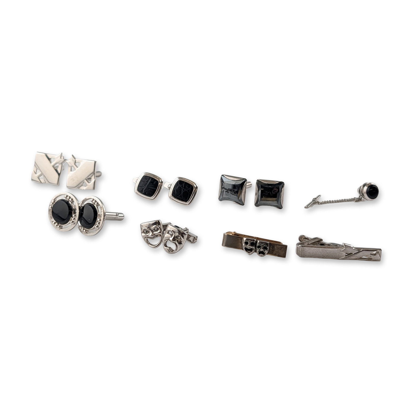 Collection of Silver-Tone Men's Jewelry, Cufflinks, Tie Clips and Tie Pin: Vintage and designer style. Collection of men's jewelry in silver-toned metals, featuring five pairs of cufflinks, two tie bars, and a tie tack. Highlights include a pair of theater mask comedy and tr