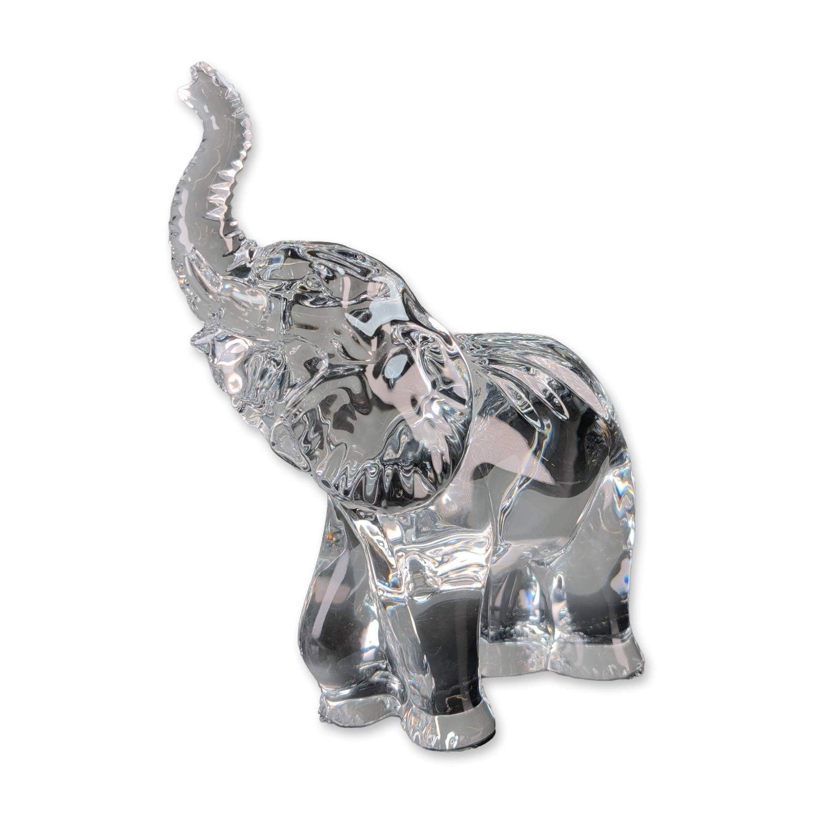 Waterford Crystal Elephant Figurine: Waterford Crystal elephant figurine in polished clear lead crystal, depicted with trunk raised. The figurine features molded details to the ears, trunk, and legs. Marked with an acid-etched maker's ma