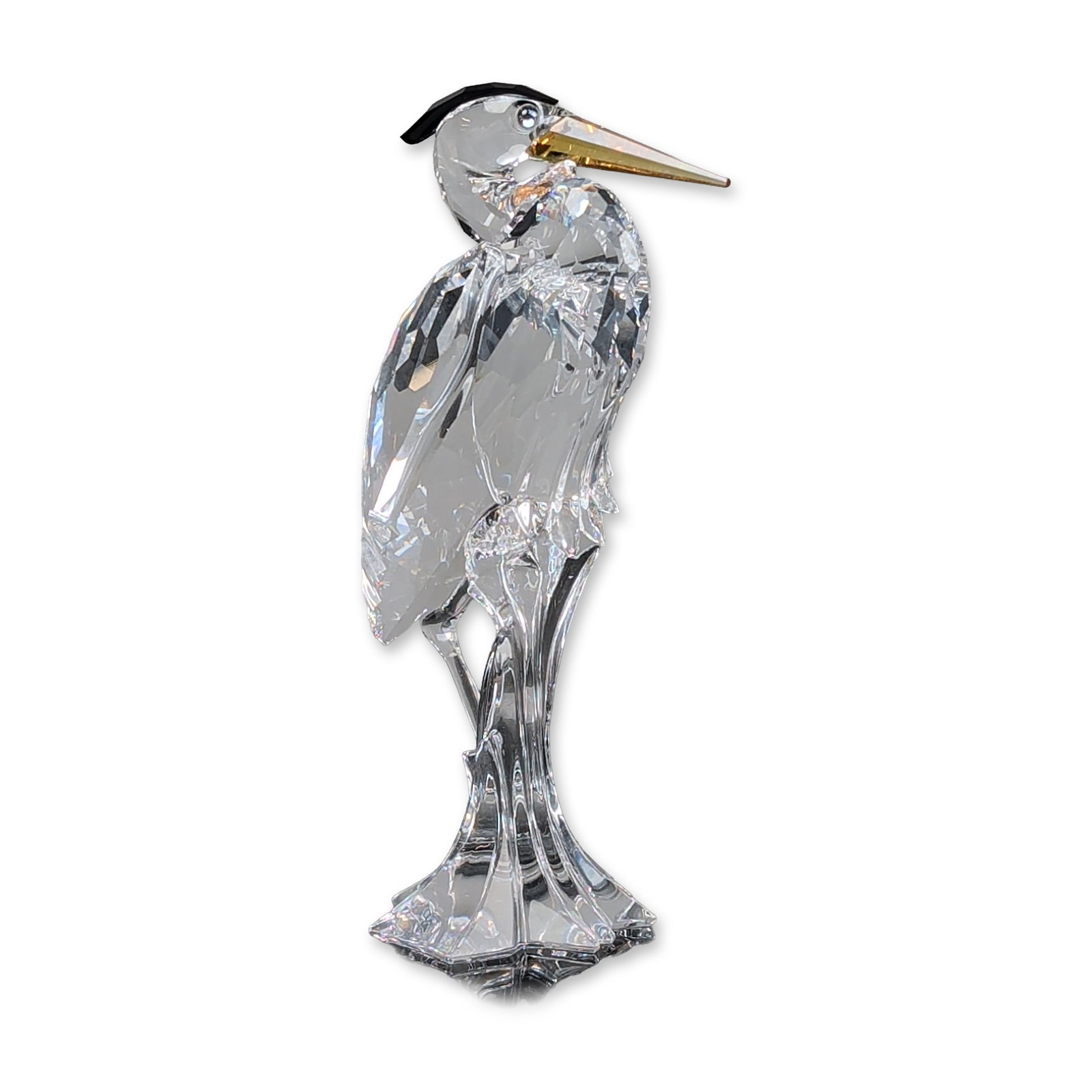 Swarovski Silver Crystal Figurine, Silver Heron: Heron figurine in faceted lead crystal, featuring an amber-colored crystal beak and black crystal crest. The bird is depicted standing on a clear crystal base with a body composed of multiple light-re