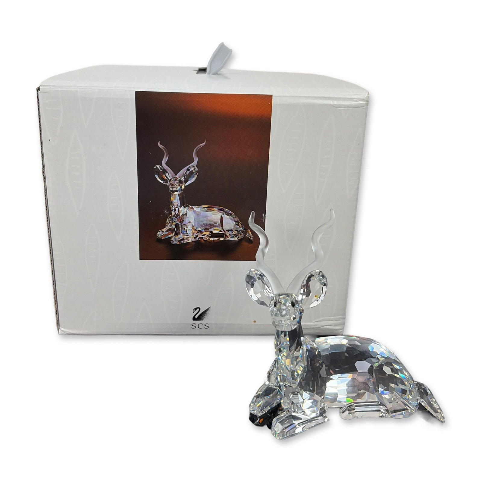 Swarovski Inspiration Africa Signed Crystal Kudu Figurine: Swarovski Kudu figurine from the SCS 1994 Annual Edition Inspiration Africa series, in faceted clear lead crystal with frosted spiral horns and black crystal eyes. Etched with Swarovski swan logo and 
