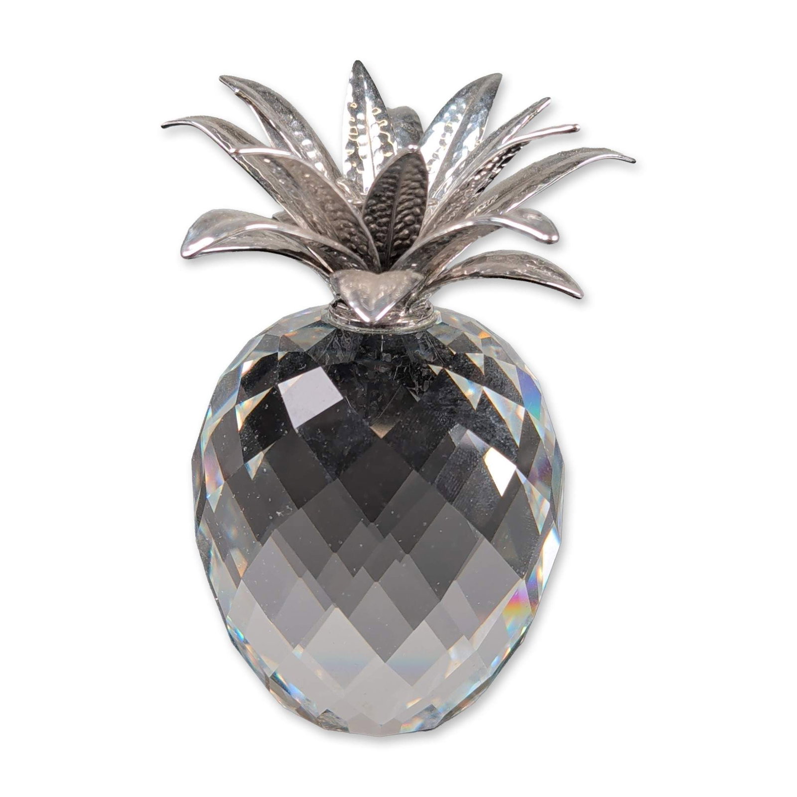 Swarovski Silver Crystal Figurine, Large Rhodium Hammered Leaves Pineapple: Swarovski Silver Crystal pineapple figurine featuring a multi-faceted lead crystal body and hammered rhodium crown. The metal leaves are designed with a polished exterior and a stippled, textured inte