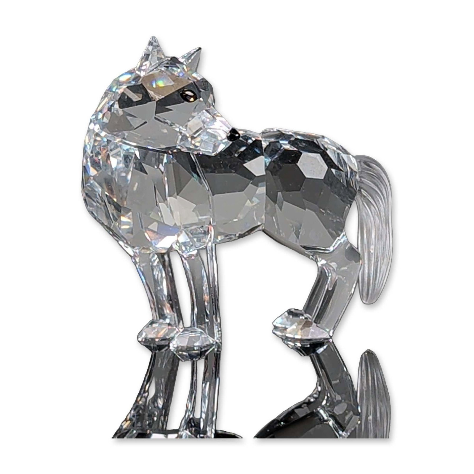 Swarovski Silver Crystal Figurine, Wolf: Wolf figurine from the Fairy Tales collection, crafted in faceted lead crystal with a frosted textured tail. Features black crystal accents at the eyes and nose. The wolf is depicted in a standing pos