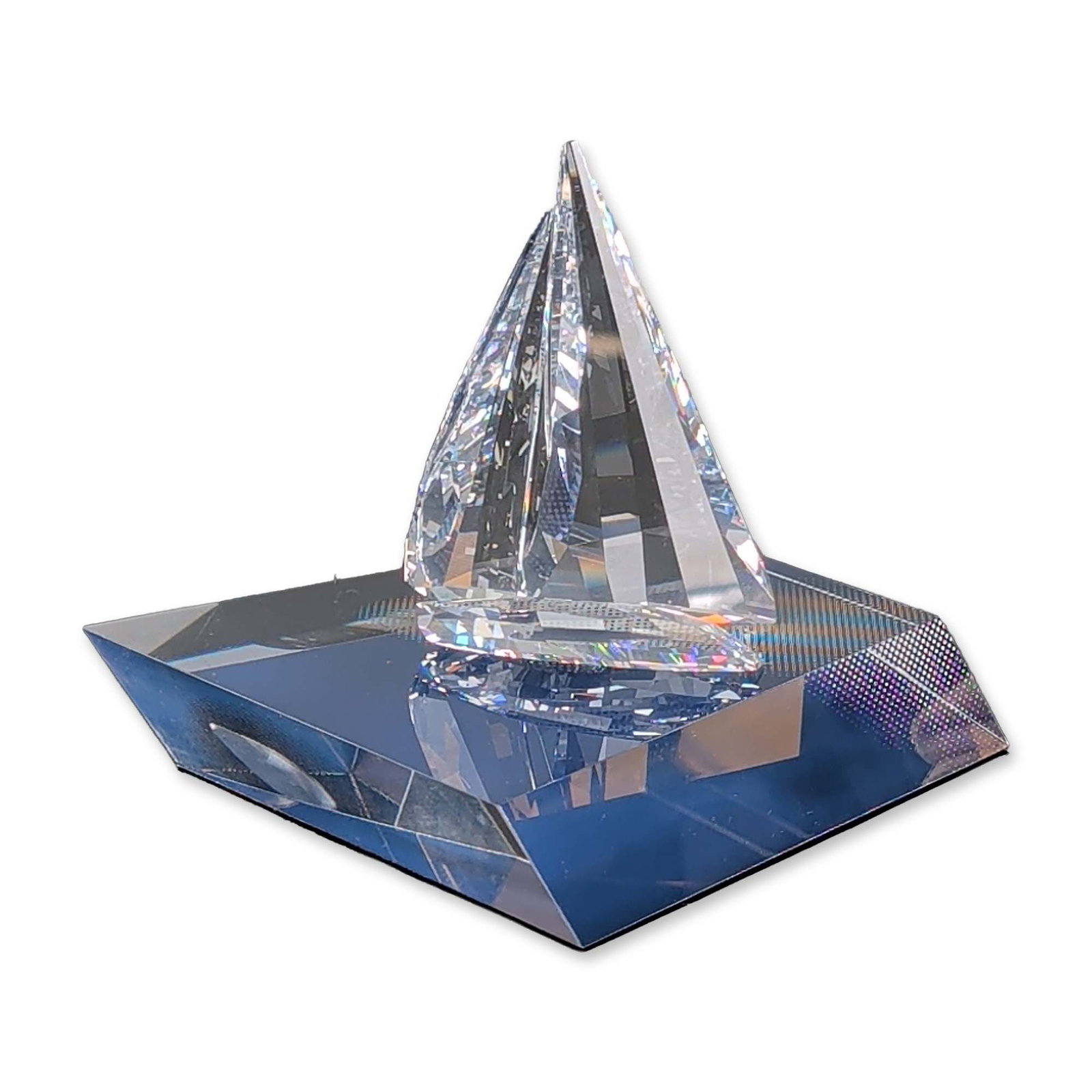 2pc Swarovski Crystal Sculpture, Sailing Legend with Base: Swarovski modernist geometric sculpture in precision-cut lead crystal, featuring a clear multi-faceted sails with deep midnight blue faceted base. The piece includes an incised Swarovski signature and