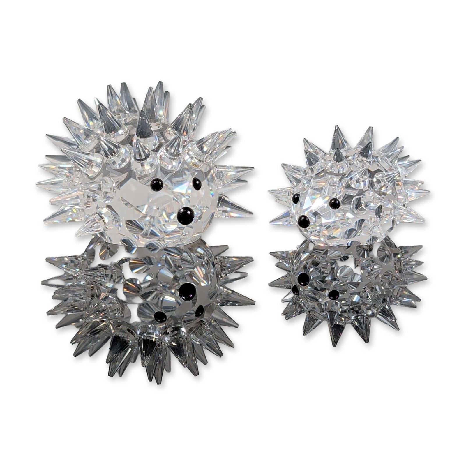 2pc Swarovski Silver Crystal Hedgehog Figurines: Swarovski. Pair of hedgehog figurines in faceted lead crystal from the Silver Crystal collection. Each figure is detailed with numerous pointed crystal quills and inset black crystal beads representin